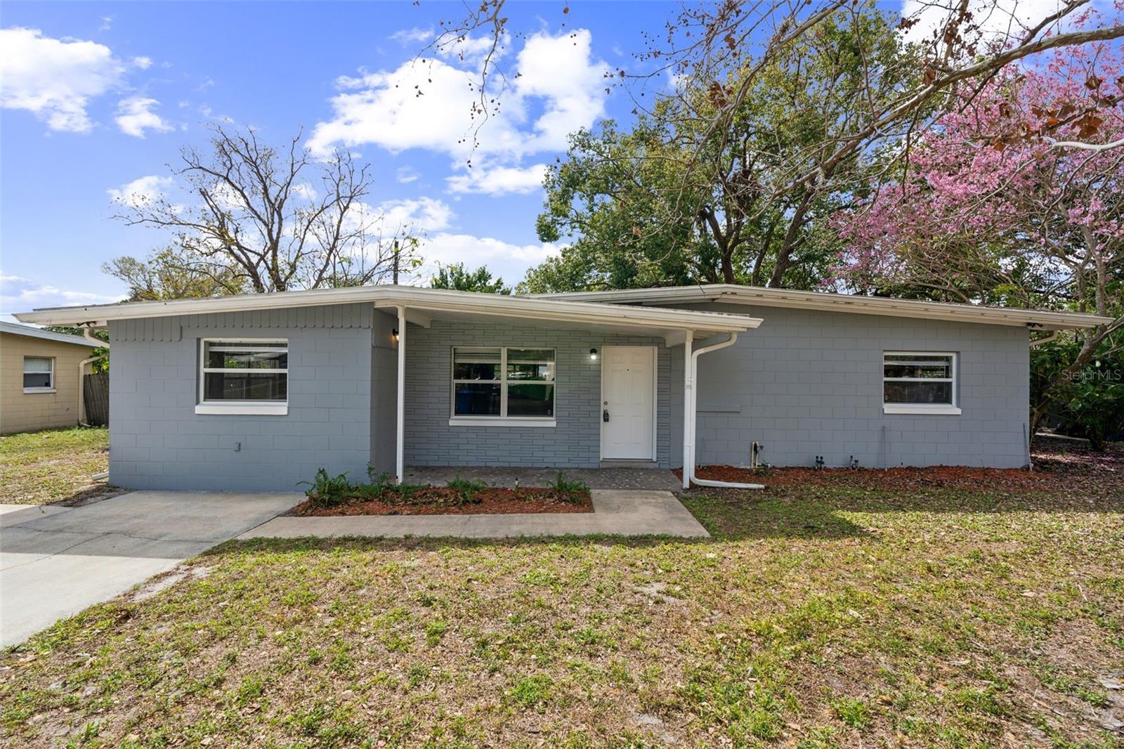 This charming 3-bedroom, 1.5-bathroom home offers 1,334 sq ft of living space. This property features a spacious floor plan and a well-equipped, upgraded kitchen with stainless steel appliances, upgraded backsplash tile, and a beautiful farmers' sink. It has a popular gray exterior with gutters for our rainy summers and neutral colors on the interior. The large fenced backyard with a screened-in lanai provides ample space for outdoor family activities and BBQs and is also great for pets. Located near public Starke Lake, the new downtown Ocoee district, and major highways like the 408, this home offers both convenience and comfort.