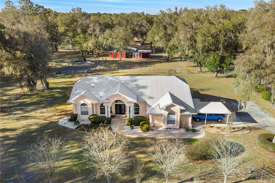 Discover the perfect blend of country charm, modern comfort, and built-in income on this exceptional mini farm just outside Ocala. Situated on just under 8 beautifully maintained acres, this unique property features two residences, equestrian amenities, and outstanding recreational spaces, ideal for multigenerational living, rental income, or a private retreat.

The primary residence offers 3 bedrooms, 2 bathrooms, and a flexible office space, all thoughtfully updated. The fully renovated kitchen shines with quartz countertops, brand-new stainless steel appliances, custom cabinetry with copper hardware, a designer backsplash, and a large center island. The open living area flows seamlessly to an expansive covered lanai overlooking a private resort-style pool with a waterfall, perfect for entertaining or relaxing in total privacy. Major upgrades include a 2023 HVAC, 2021 water heater, 2-year-old well pump, and a durable metal roof (2009). Additional features include an RV port, a carport, and three storage sheds, two have electricity, and one has water.

Equestrian and outdoor enthusiasts will appreciate the 4-stall center-aisle barn complete with tack room, feed room, and fenced pastures, and a truly spectacular custom treehouse.

The second residence is a 2016 manufactured home offering 4 bedrooms, 2 bathrooms, and 2,280 sq ft of stylish living space fully furnished. Featuring luxury vinyl plank flooring, tray ceilings, an open floor plan, and a massive front porch, this home is currently tenant-occupied with a long-term lease, providing immediate passive income. It also has its own private driveway for added privacy.

Conveniently located near shopping, dining, hospitals, and outdoor recreation and just 20 minutes from the renowned World Equestrian Center, this one-of-a-kind property offers lifestyle, location, and income potential all in one. A rare opportunity you don’t want to miss!