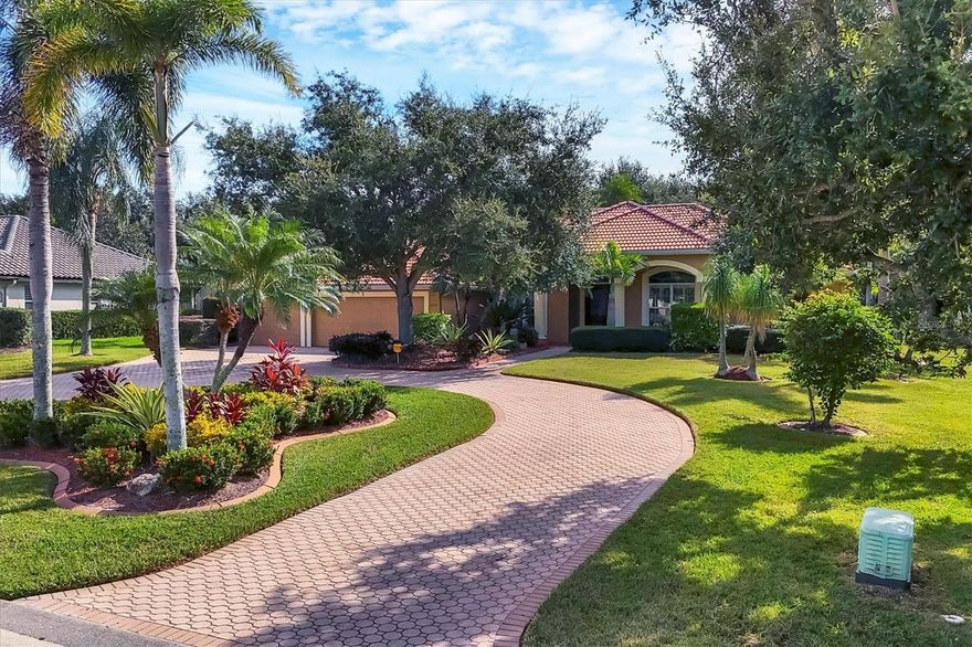 Elegant Custom-Built Home in River Wilderness-Parrish, Florida. Welcome to your own slice of paradise in the prestigious River Wilderness Golf and Country Club Community. This custom-built home offers just under 3000 square feet of living space on a serene half acre lot, sitting on a lake and surrounded by mature trees and lush landscaping that provide both beauty and privacy. Step through the custom California "speak-easy"wood double doors into a grand foyer that opens to a bright spacious floor plan. To your right is a comfortable den, perfect for a home office or study; to your left is a spacious dining area ideal for entertaining. Straight ahead, the large living room features expansive sliding glass doors that open to a generous lanai half under roof and half screened-overlooking the inviting pool with hot tub and tranquil views of the spectacular sparkling lake and natural landscaping. The open kitchen boasts rich wood cabinetry and ample granite counter space, seamlessly connecting to the living and dining areas. This home offers three oversized bedrooms. The primary has two walk in closets with california interior. The other two bedrooms have large closets. All rooms have very high ceilings from 9'4" to 12'4". The indoor utility room has washer and dryer as well as a sink and plenty of cabinet space. The oversized three car garage provides plenty of room for vehicles and a workshop or storage. Designed for both comfort and security, this gated community features a guarded entrance gate. Residents enjoy access to the River Wilderness Country Club, which offers optional membership for golf, tennis, dining and social events as well as a community boat ramp for exploring the nearby Manatee River. Large windows fill every room with natural light. The primary suite features sliding doors that open directly to the lanai, creating a seamless indoor-outdoor flow. This home is both sturdy and serene. AC new in 2019, Electric hot water heater new in 2018. Experience the perfect blend of elegance, space and Florida lifestyle-all within the secure, beautifully maintained setting of River Wilderness. When you arrive you will understand why residents call it Paradise.