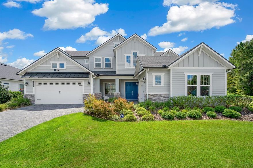 Experience elevated living with over 3,916 square feet this home offers a versatile layout ideal for everyday living and entertaining. Luxury and comfort come together in this nearly new Craftsman-style pool home, ideally situated on a premium corner lot in the sought- after Oakmont community. A brick-paver driveway, framed by both a 2-car and additional 1-car garage, sets the stage for this beautifully designed 5-bedroom, 3.5-bath residence, complete with a dedicated office with closet (or optional 6th bedroom) for ultimate flexibility.

From the moment you enter, you’ll notice the thoughtful craftsmanship and open design that perfectly blends indoor comfort with Florida’s outdoor lifestyle. Towering two-story windows flood the entryway with natural light, highlighting the soaring ceilings and dramatic catwalk above. At the center of the home, the expansive great room flows seamlessly into the gourmet kitchen, making it an entertainer’s dream.

The chef’s kitchen showcases a large granite-topped island, stainless steel appliances with a 5-burner gas cooktop, walk-in pantry, and under-cabinet lighting. Retreat to the private primary suite, where you’ll find an oversized custom closet with wood shelving and a spa-like bath featuring dual granite vanities, a soaking tub, and a walk-in shower.
Upstairs, a spacious loft-style catwalk leads to a cozy reading nook and a versatile bonus/flex room. Four generously sized secondary bedrooms are also located on this level, with two sharing a convenient Jack-and-Jill bath.

Step outdoors to the expansive covered lanai, complete with a summer kitchen featuring a gas cooktop, grill, refrigerator, sink, ceiling fan, and paver flooring. The screened-in pool and spa create the ultimate private retreat, framed by a beautifully landscaped, fenced backyard.

Additional highlights include crown molding, recessed lighting, wood-look porcelain tile flooring, triple-zoned dual HVACs, upgraded internet/security systems, gutters, irrigation, landscape lighting, and a premium solar panel system powering both the home and pool.
Oakmont is known for its vibrant community feel and world-class amenities: tennis courts, amphitheater, resort-style pool, basketball courts, activity field, banquet spaces, and more—all just minutes from the University of Florida and Shands Hospital. With its unbeatable blend of location, lifestyle, and luxury, this home is truly a rare find. Schedule your private showing today!