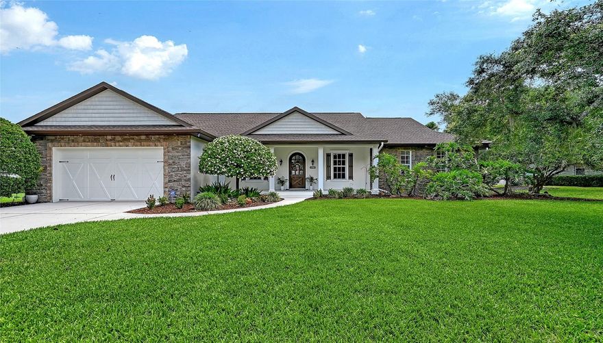 Welcome to this beautifully maintained former model home in Mill Creek, where spacious living, timeless details, and privacy come together on an oversized preserve-view cul-de-sac lot. Offering 3 bedrooms, 3 bathrooms, approximately 2,440 square feet, and a 2-car garage, this residence showcases quality craftsmanship and thoughtful design throughout. Set back from the street with an expansive front yard and a charming front porch that spans the width of the home, the property offers exceptional curb appeal and a warm, welcoming presence.
From the moment you enter through the impressive solid wood arched front door, you’ll notice the attention to detail including crown molding, architectural arches, built-ins framed by brick accents, and an open, flowing floor plan designed for both everyday living and entertaining. Glass French doors lead to a private den/office space, while the separate dining room provides an elegant setting for gatherings and holiday meals. The open-concept kitchen and family room serve as the heart of the home, featuring warm wood 42" cabinetry with accent lighting, granite countertops, stainless steel appliances, a wine refrigerator, dry bar, large kitchen island with seating for four and a pass-through buffet. The spacious enclosed lanai offers the perfect setting for dining, relaxing, and entertaining while overlooking the large backyard with ample room to add a private luxury pool. The oversized primary suite is a true retreat, complete with two walk-in closets, dual vanities, separate water closets, and a stunning oversized walk-through shower. A tray ceiling with accent lighting adds warmth and elegance to the space. Two generously sized guest bedrooms feature new carpet, while the large secondary bathroom with direct lanai access provides comfort and convenience for family and guests alike. Additional highlights include low HOA fees, newer roof, newer HVAC, new tankless water heater, and central vacuuming system.  Mill Creek is known for its larger homesites, mature landscaping, and welcoming neighborhood feel with room to spread out while remaining conveniently located near Lakewood Ranch, top-rated schools, dining, shopping, and Gulf Coast beaches. This exceptional property offers the perfect blend of elegance, comfort, and Florida lifestyle living.