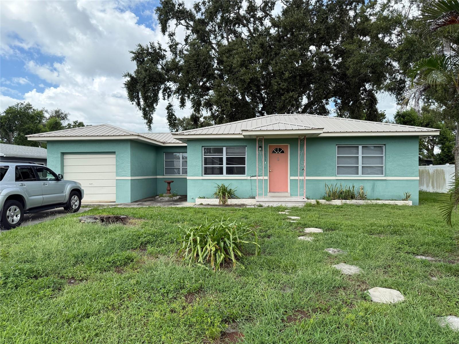 Hi and Dry. Cute bungalow with hardwood floors. Large live oak shaded back yard with storage sheds. One is quite large and the other is barely hanging together. Conveniently located in the county.