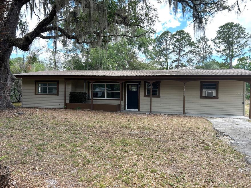 WELCOME TO RIDGE MANOR! This 3 bed 1.5 bath home is being  tastefuly renovated featuring CATHEDRAL CEILINGS! that adds an open and airy feel. Home offers many extras including a covered front porch for a welcoming spot to enjoy the shaded front yard, a beautiful fireplace, a floorplan that provides a functional layout with comfortable living spaces, updated lighting, fixtures, appliances and all new vinyl plank flooring  throughout, a screened in lanai for relaxing outdoor living with added comfort and TWO BONUS ROOMS! for extra flexable space . Home sits on an oversized DOUBLE LOT! AT 0.80 acres with plenty of space for outdoor hobbies and entertaining. Enjoy the feel of a peaceful quiet neighborhood with easy access to nearby services and major routes for commuting. Schedule your showing to come and explore all of the potential this home has to offer.