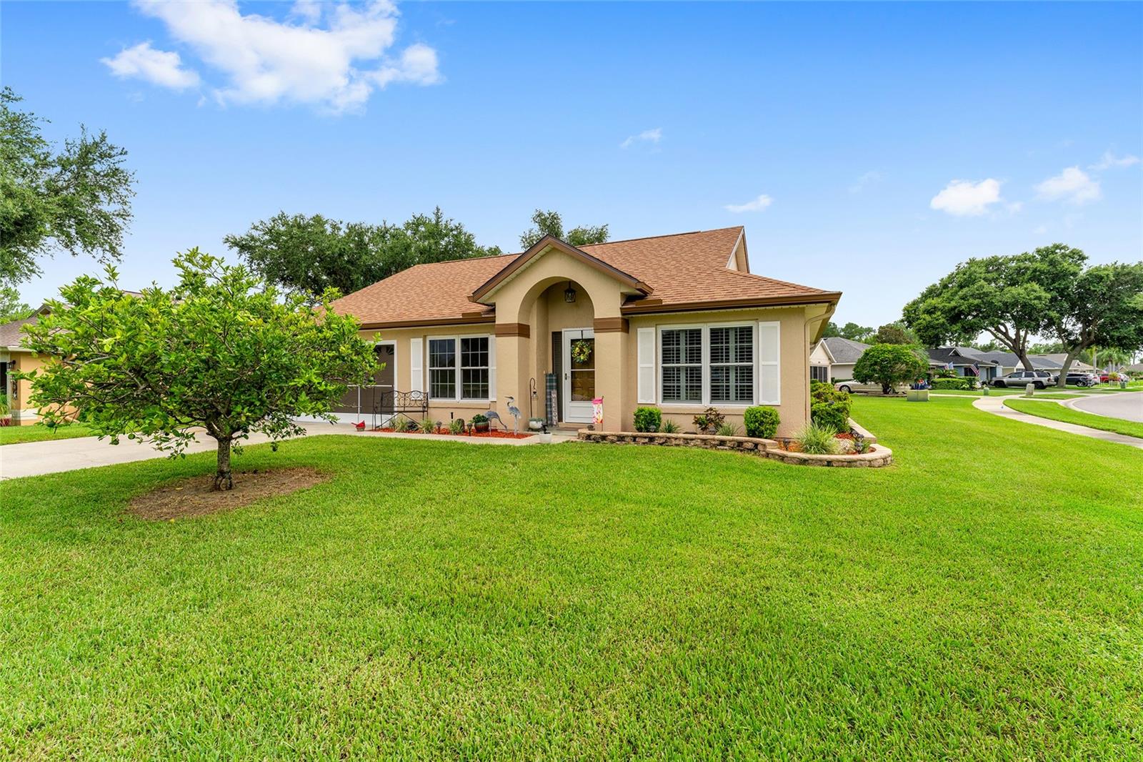 Beautiful BLOCK & STUCCO Home -- In a SUPER LOCATION!! Tavares Imperial Village (HOA neighborhood) is across the street from LAKE EUSTIS BOAT LAUNCH and Behind “Salsa” Restaurant on 441!! -- ** This home is on a CORNER LOT – 3 Bedrooms, 2 Baths and FLORIDA ROOM!! -- 2022 Roof – 2019 HVAC -- Safe-Step WALK-IN JACUZZI TUB in Hall Bath!!! -- Vaulted & High Ceilings – PLANTATION SHUTTERS - Ceiling Fans – Laminate Flooring thru out and Carpet in Primary Bedroom!! – Kitchen with White Cabinets & Stainless Appliances, LG “ThinQ” Refrigerator (French Door/Bottom Freezer) and “ThinQ” Flat top Electric Range, LC Stainless Dishwasher, and Mounted Microwave. Kitchen Closet Pantry and Eating Space in Kitchen with a Breakfast Bar Overhang /Pass thru to Dining Room -- BBQ Pad with Pergola Cover in Back, Gutter & Downspouts, and Landscape Beds with fresh Mulch! – Primary Bedroom (carpet) with a Walk-in Closet & Private En Suite Bath with Step-in Shower. -- Laminate Flooring in the Guest Wing! Hall with Linen Closet and Bedroom 2 with French-Door Entry and Bedroom 3 with an extra nook space for a sitting area! – Guest Bath has the Safe-Step WALK-IN JACUZZI TUB. – FLORIDA ROOM with Top-Down/Bottom-Up Levelor Blinds on Windows, and Door to BBQ Pad. – Garage with Work-Bench, GE Washer & Electric Dryer, Stairs to Attic, irrigation System, and GARAGE DOOR SLIDER SCREENS. – LOCATION IS KEY!!! (HOA is $250/year)