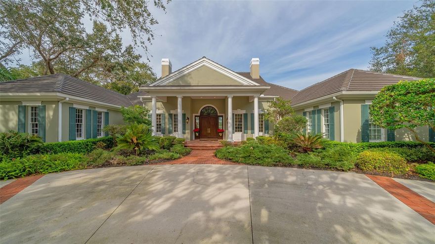 On the market for the first time, the sellers had this 4 bedroom (plus study), 3.5 bath house custom built by Baron as their dream home.  And now, you can make this spectacular home yours! It will be love at first sight when you drive up to this sprawling abode with circular driveway.  Walk through the double front doors, and the interior will treat your senses. In front of you lies the formal living room with a view out the enormous walls of glass overlooking the pool to an amazing lake view. To the right is the open formal dining room, which is a work of art unto itself.  There is an incredible wet bar that serves all the entertaining areas of the house. Gather with your guests and loved ones in the open kitchen/den area, which is the heart of this home. Equipped with high-end appliances, including a gas range, the kitchen has everything the chef needs to create gourmet meals, including a built-in desk for menu planning.  The adjoining breakfast area and den with fireplace have access to the lanai, and gorgeous lake views. The master suite is big and beautiful. The bedroom is spacious with room for a sitting area, it has a large walk-in closet and sliders to the lanai. The Vegas style en suite bathroom has two sides, which can serve as his-and-hers, and a shared walk-in shower.  The study is reminiscent of another era yet has a timeless elegance. Quality wood, including built-ins, surround you. The fireplace lends a cozy touch to this versatile room that can be used an office, library or man cave. The large laundry room with window has a utility sink and tons of cabinets for storage. The screened lanai has two large covered areas, a built in grill and sink, free form pool with spa and those lovely lake views you will never get tired of.  Add to all this a newer roof, soaring ceilings, 8 foot solid wood doors, ceiling fans, tray ceilings and crown molding and you couldn’t ask for anything more.  Don’t let the opportunity to make this your Gulf Coast dream home.  The Oaks Bayside is located on the west side of Tamiami Trail, on the banks of Little Sarasota Bay. Surrounded by Historic Spanish Point and conservation land, it enjoys a tranquil, natural setting. There is a community dock for use by residents; fish, launch a kayak or just sit quietly and watch the daily show of glorious color put on by the evening sunsets. The Oaks Club has two golf courses, a driving range, 12 HAR TRU tennis courts (4 lighted), 4 new pickleball courts, croquet court, a WellFit center, and 3 onsite restaurants. Club membership is required with homeownership.