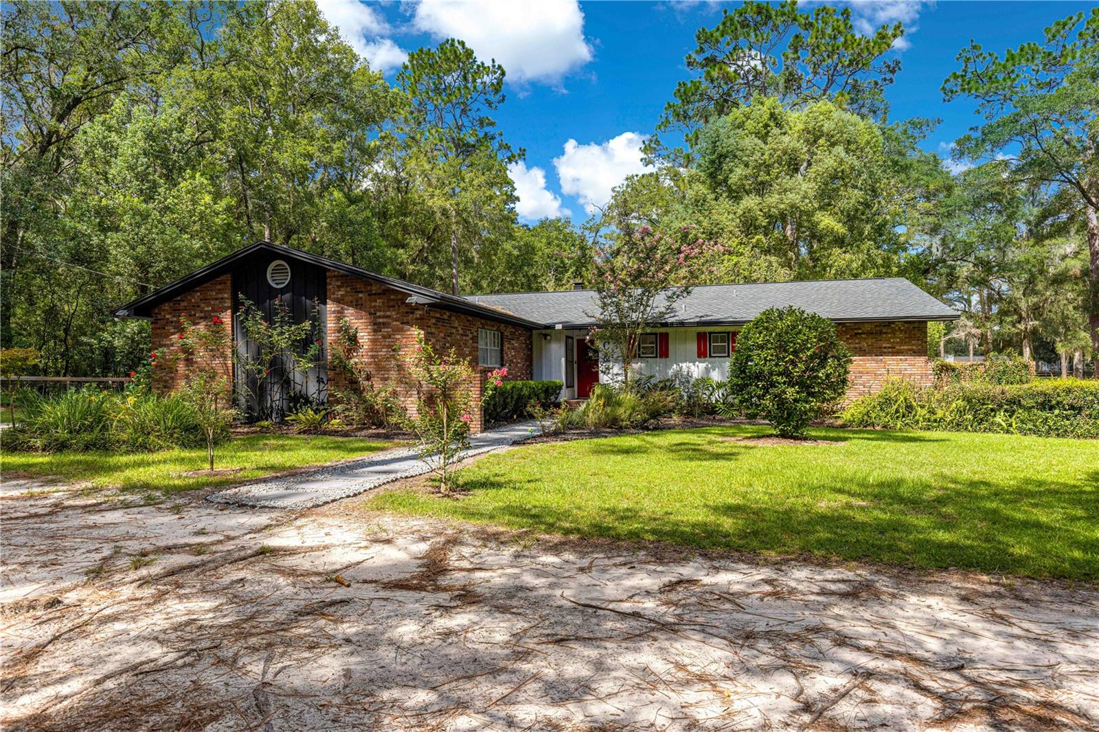 Welcome to this beautifully updated 5-acre mini farm, a perfect blend of comfort, charm, and functionality. The property is fully fenced with top board and no climb and features a brand-new 8-stall center aisle barn with 12x12 stalls, each equipped with automatic waterers and hay mangers. Additional equine amenities include a hot and cold wash rack, an air-conditioned tack room with washer and dryer hookups, solar lighting at both ends of the barn, and security cameras for added peace of mind. A 100x140 riding arena with a clay and sand mix provides ideal footing, while three shaded paddocks have ample turnout space. The barn area is accessed through a double automatic gated entrance, ensuring both security and convenience.
The land is dotted with mature live oak trees and boasts lush Bahia grass fields, two wells, two septic systems, and two power meters, making it ideal for a variety of uses. For guests or travelers, the property includes both a 30 amp and a 50 amp camper site. Additional features include a chicken coop and a cozy outdoor fire pit, adding to the property’s country charm.
The renovated 3-bedroom, 2-bath ranch-style home offers both style and comfort, with a spacious family room, a cozy living room with a fireplace, and a beautifully updated kitchen featuring new appliances, butcher block counters, and modern lighting. Luxury vinyl flooring runs throughout the home, which is accented with crown molding in every room. The home also includes a 2.5-car garage and a large 32x16 deck overlooking the barn and pastures. With a new roof, fresh paint inside and out, and two automatic gated entrances, the home is move-in ready. The lush landscaping, including magnolia trees, azalea bushes, and a rose garden, provides both privacy and stunning curb appeal.
This property offers character, charm, and all the amenities you need for comfortable country living.