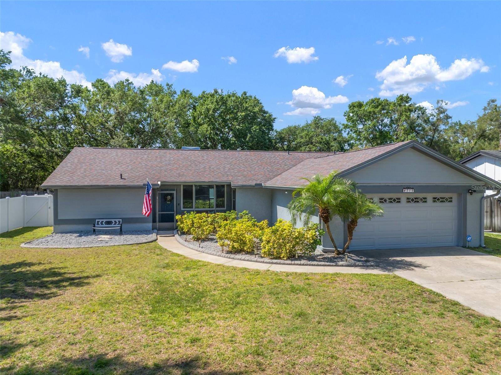 Tucked away on a private lot in the heart of Carrollwood, this beautifully maintained three-bedroom, two-bathroom home with a two-car garage effortlessly blends comfort, function, and style. From the moment you enter, you are welcomed by an open, airy layout and a warm wood-burning fireplace that anchors the great room. The kitchen overlooks the living space and offers serene views of the sparkling pool and landscaped backyard, creating a seamless indoor-outdoor experience ideal for both relaxing and entertaining. This residence has been thoughtfully enhanced with a long list of upgrades, including a newer roof (2019) with added nails for even more insurance savings, remodeled primary bathroom, upgraded electrical panel with generator hookup, tankless water heater, hurricane-rated garage door with modern opener, and newer double-pane PGT impact windows. The pool has been resurfaced with updated tile and decking, and the lush landscaping is framed by concrete curbing and a white vinyl privacy fence. Additional features include recessed lighting, an upgraded irrigation system, a child safety fence for the pool, and added storage shelving in the garage. The exterior of the home is equally impressive, with fresh paint, newer siding, and permanently affixed LED roof lights, providing effortless, year-round festive lighting with the push of a button. With low HOA fees, no CDD, and access to community amenities such as tennis courts, basketball courts, and multiple playgrounds, this home is located in one of Tampa’s most desirable neighborhoods. Pride of ownership is evident throughout! With close proximity to nearby shopping, dining, North Dale Mabry Highway and the Veteran’s Expressway, this is Carrollwood living at its finest. Call today to schedule your private showing!
