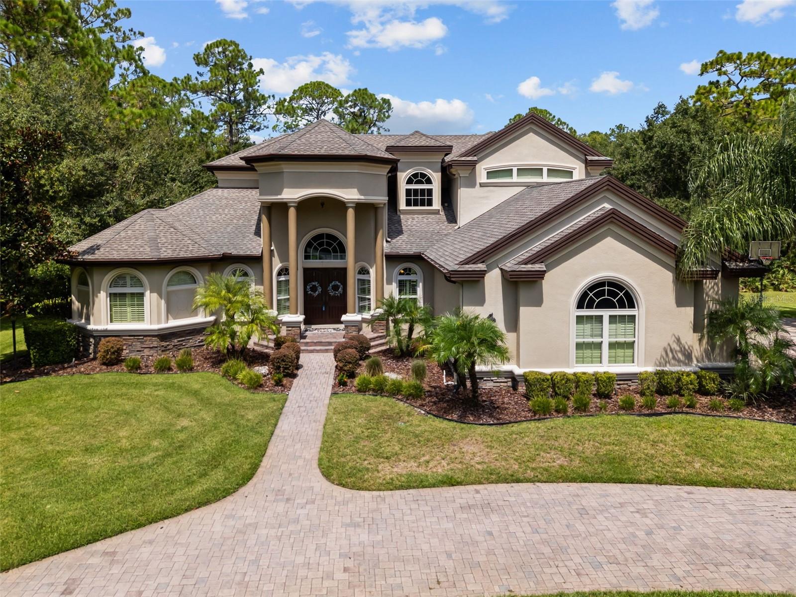 Welcome to Aristida, where homes rarely come available! This Samuelson Builders custom estate is tucked away on over 3 acres, surrounded by the Starkey Wilderness Preserve. You’ll feel completely private and connected to nature, yet you’re just minutes from all that Trinity and New Port Richey have to offer, restaurants, shopping, Trinity Hospital, golf, area beaches, and more.
From the moment you step inside, this home makes an impression. A large foyer and great room with a soaring coffered ceiling and a curved staircase create a stunning first look. The kitchen is truly a dream with a gas range, built-in oven, custom cabinetry, and walk-in pantry. On the first floor, you’ll also find the primary suite, private office, and three additional bedrooms. And don’t miss the built-in bookcase with a secret door that opens to a hidden room under the staircase, a special touch that makes this home stand out. Upstairs is all about fun and flexibility with a media room, a spacious bonus area big enough for a pool table along with 2 more bedrooms and a full bath.
With 6 bedrooms, 4.5 baths, and more than 4,000 sq ft, there’s room for everyone. Thoughtful upgrades include storm impact windows, a brand-new AC (2023), propane gas, water softener with reverse osmosis, and a pre-wired security camera system. Outside, the saltwater pool and large pavered patio set the stage for relaxing or entertaining, and with tons of yard space for all your favorite activities you'll feel right at home.
This is a special opportunity to own in Aristida — a home that truly offers space, privacy, and lifestyle.