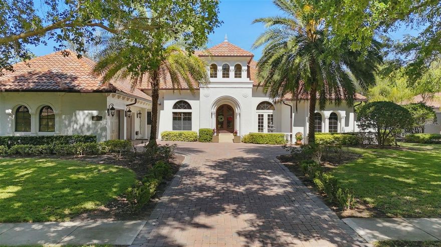 Highly sought after custom home in Reserve at Lake Butler Sound. Beautiful iron arched double doors welcome you to an open floor plan with travertine floors and a view to the pool/lanai. Wrought iron chandeliers adorn the entry and spacious dining area. Upgraded features are aplenty in this beautiful home including top-of-the-line appliances, 2 gas fireplaces, and high ceilings. The large gourmet kitchen flows into the breakfast area family room with custom built entertainment wall and floor-to-ceiling 10' corner sliding glass doors that open fully to a large screened in porch complete with a fireplace and built-in outdoor kitchen. The kitchen has an enormous center island, Dacor and Sub Zero appliances including a 6-burner gas stove top, 2 ovens, and a wet bar with wine fridge and warming drawer. There is also a spacious walk in pantry. The first floor has a game room with full bar, an office, and three bedrooms in addition to a large primary suite. The primary suite has hand-scraped wood floors, an oversized bathroom with dual vanities, a private courtyard, and a large walk in closet. Upstairs there is a bedroom, full bath, and a theater room with theater seating for 6, screen and projector. There is plenty of garage space with 3 garage bays, attic access and ample storage. The fenced backyard features a large pool with spa and water features. This home comes partially furnished with designer furnishings as shown in the photos. Close to shopping, dining, expressways, tourist attractions, top-rated public and private schools including Windermere Preparatory Academy.