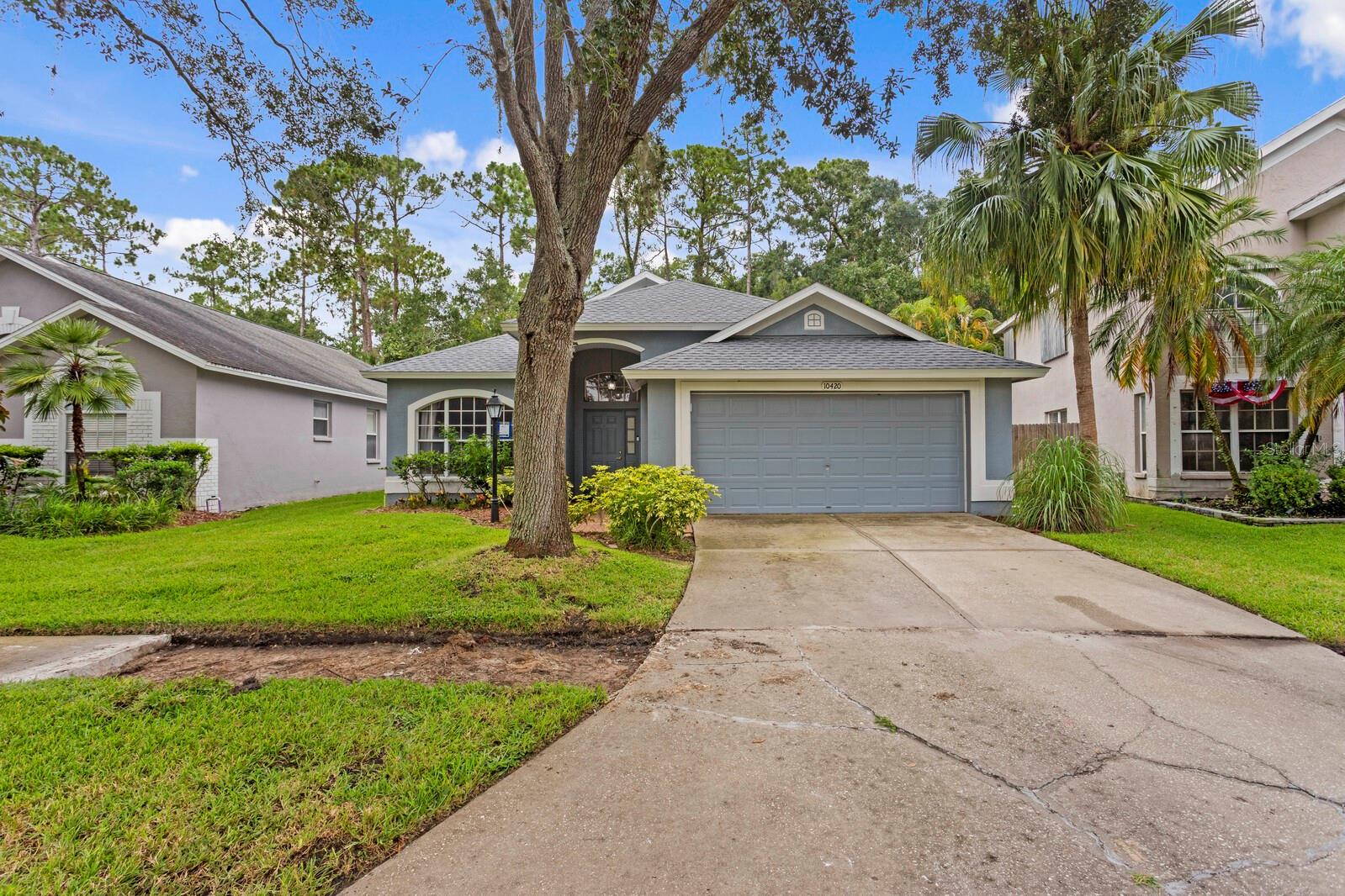 Welcome home to this 5 bedroom, 2 bathroom house in the heart of Westchase, featuring a brand new roof and unbeatable location! Nestled on a tree-lined street, with a new sidewalk being installed by the HOA, this spacious residence features a split-bedroom layout with multiple living and dining areas, offering both comfort and flexibility. The private master bedroom includes an additional living space, a walk-in closet, and a generous en-suite bathroom. The kitchen is a standout, complete with wood cabinetry, a center island, stainless steel appliances, a gas range, and a charming breakfast nook. Vaulted ceilings in the family room create an open, airy feel, with direct access to the back porch and yard, which is perfect for relaxing or entertaining. Four additional bedrooms are situated on the opposite side of the home, providing ideal separation and privacy. Residents enjoy access to top-rated schools and exceptional community amenities, including a pool, tennis courts, pickleball, parks, and more, all with convenient proximity to the Veteran’s Expressway, Tampa International Airport, and Gulf beaches. Don’t miss this opportunity to make Westchase your home.