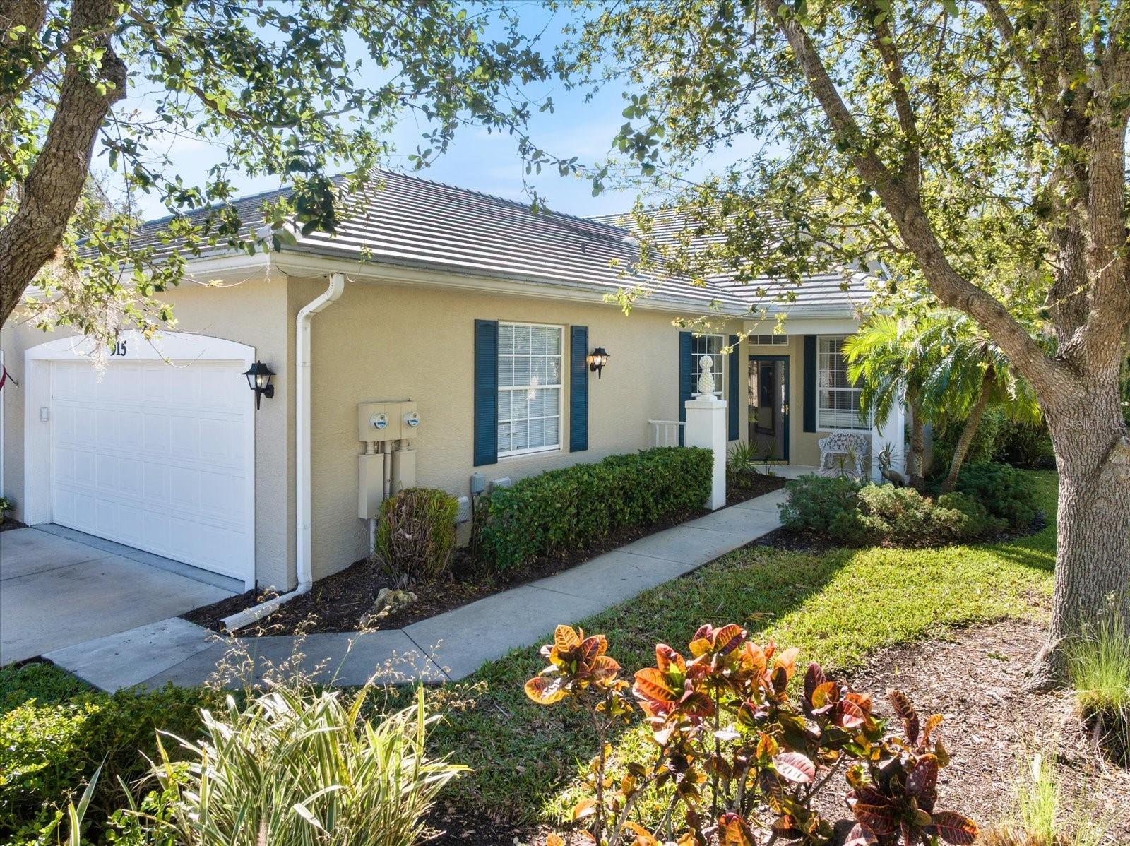 MOTIVATED SELLER! PRICE REDUCTION TO ALLOW FOR NEW FLOORING OR PERSONAL UPGRADES! Welcome to this serene maintenance-free VENICE VILLA in the highly desired community of St. Andrews Park of Plantation Golf and Country! This spacious home features 2 BEDROOMS, DEN (Optional 3rd BEDROOM) and 2 BATHROOMS. The home is nicely situated on a quiet, dead-end road, and offers a convenient location to the relaxing community pool across the street. The backyard features tranquil peaceful nature views of your own TROPICAL GARDEN! This preserved nature setting is a real gem of this home and offers hours of relaxation. No development will occur as it adjoins to the 13th hole of the Bobcat course. This lovely home comes “MOSTLY FURNISHED” and is MOVE-IN ready! Features include tall, cathedral ceilings, open layout, extended living room, split bedrooms, a bonus area off the kitchen for storage (or a craft area), plus a 2-car garage! The dining room showcases a high counter bar with conveying dining table. The spacious living room offers a conveying sofa, table set and Mid-Century armoire, while the bright kitchen conveys a cute round wicker table. The large master bedroom features 2 separate closets, beautiful southern exposure to your tropical garden and offers conveying wicker set. The en-suite master bathroom has a soaker tub, pocket commode and separate shower. The guest bedroom also has conveying wicker furniture. The cozy Den feels like a quiet reading room with its soothing blue walls and conveying leather sofa, chairs and wicker armoire. The Tile Roof was replaced in 2023, A/C 2018, Water Heater 2023. There is a new 4-point inspection recently performed and available to view. The HOA covers exterior, roof, water/sewer, basic cable, all lawn care, pest control, annual laundry duct cleaning, and maintenance of all the community pools. This premier lot offers much privacy with a preserve backyard, quick access to the neighborhood community pool (literally across the street), and is conveniently close to the MAIN PLANTATION GOLF and COUNTRY CLUB offering “OPTIONAL MEMBERSHIPS” in GOLF, SOCIAL or TENNIS! There's also 2 more St. Andrew's community pools just down the street to enjoy as well, one offering year round social activities! Plantation is a lifestyle community, yet Memberships are NOT MANDORATY and offer PREMIER GOLFING with 2 pristine courses, dining & lounging, Har-Tru tennis, pickle-ball, bocce ball, fitness center, a large community pool, plus a variety of social events! This is an ideal location, just off of CENTER RD, and only minutes to the NEW Wellen Park (with many new restaurants). And Downtown Historic Venice is a 6 miles away offering farmer's markets, our famous Venice Theatre, an active Art Center, boutique shops and numerous authentic restaurants from Greek, Italian to French! There's an appetite for everyone! Plus our area beaches offer amazing sunsets, drum dance circles, and the area's only DOG BEACH, Bohard Beach and Paw Park, a favorite to bring your furry friend to beach with you! Plus, our new state-of-art Sarasota Memorial medical facility is only 8 miles away! Call for your private tour! This is a community where neighbors will know your name!
