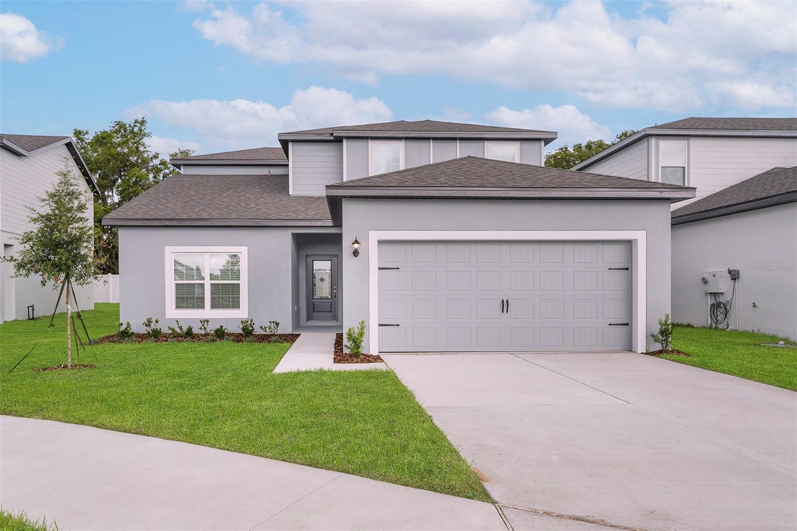 NOW AT A REDUCED PRICE! Our Summer Sales Event is here!
Introducing the Parc floor plan in the tranquil Tula Parc community of Astatula. This stunning two-story home offers 4 bedrooms and 2.5 bathrooms, each bedroom featuring its own walk-in closet, providing ample storage for families and guests.
The chef-ready kitchen is a culinary delight, seamlessly flowing into the open-concept family and dining areas—ideal for entertaining and creating lasting memories.
The Parc floor plan was designed to surpass all expectations with impressive upgrades included at no extra cost to you. This home includes a modern take on additional style and convenience. An array of energy-efficient Whirlpool®appliances, including the refrigerator, stunning granite countertops, 36” upper-wood cabinets with crown molding, Moen® faucets and LED flush mount ENERGY STAR kitchen lights are just a few of the remarkable upgrades that complete the kitchen. In addition, programmable thermostats, designer coach lighting, double-pane Low-E vinyl windows and a WiFi-enabled garage door opener give the home features and finishes today’s homebuyers are looking for.
A covered front porch welcomes you, while the covered back patio offers a serene retreat for outdoor relaxation. The private master suite includes a massive walk-in closet and a well-appointed en-suite bathroom. Enhanced with lush front yard landscaping, this home exudes curb appeal. Nestled near Little Lake Harris, Tula Parc provides residents with opportunities for boating, fishing, hiking, and golfing, all within a serene natural setting. Don’t miss the chance to make this exceptional home yours!