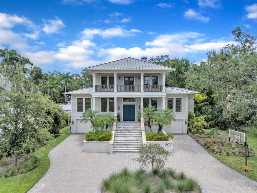 Welcome to 5010 W Dickens Avenue, a rare Sunset Park gem where timeless architecture
meets exceptional design and scale.
Nestled high and dry in one of South Tampa’s most beloved enclaves the “Poet Streets,”
this custom residence was thoughtfully designed by architect Jim Ludwig and masterfully
built by Steve Fisher of Classic Builders. With over 8,000 square feet under roof and
situated on a 220-foot-deep lot, this home is made for those who crave space, privacy, and
seamless indoor-outdoor living. This thoughtfully designed retreat has the character and
charm you simply won’t find in cookie-cutter build.
The moment you arrive, the expansive front porch with travertine pavers and a classic
porch swing creates a welcoming sense of place. Inside, grand ceilings with wood beam
accents, a tabby shell fireplace, and rich architectural finishes set the tone for casual
sophistication.
The heart of the home is the chef’s kitchen, thoughtfully designed with two islands, dual
dishwashers, a Thermador gas range and double oven, a trash compactor, and generous
prep and gathering space. It opens directly into the family room and formal dining room—
perfect for hosting everything from intimate dinners to holiday gatherings.
Step outside and experience what truly sets this home apart: a deep backyard oasis that
feels like a private resort. The oversized covered lanai, complete with a tongue-and-groove
ceiling and travertine decking, overlooks a stunning pool, lush lawn, and grill station… an
entertainer’s dream.
The main level also features the primary suite with a large walk-in closet and private office
(or flex room for a gym, nursery, or dream closet). Upstairs, you’ll find four additional
bedrooms, two full baths, and an open loft that leads to a spacious covered balcony,
offering a quiet escape or extra space for outdoor entertaining.
Car enthusiasts or those in need of extra storage will appreciate the 5-car garage with
bonus space ideal for a home gym, workshop, or recreational area. The durable tabby and
Hardie Board exterior ensures low maintenance for years to come.
Located in the coveted Mabry/Coleman/Plant school district, this home is minutes to
everything: Westshore Marina District, Tampa International Airport, and local beaches.
This is Sunset Park living at its best—where timeless architecture and custom
craftsmanship come together in a home that truly stands apart.