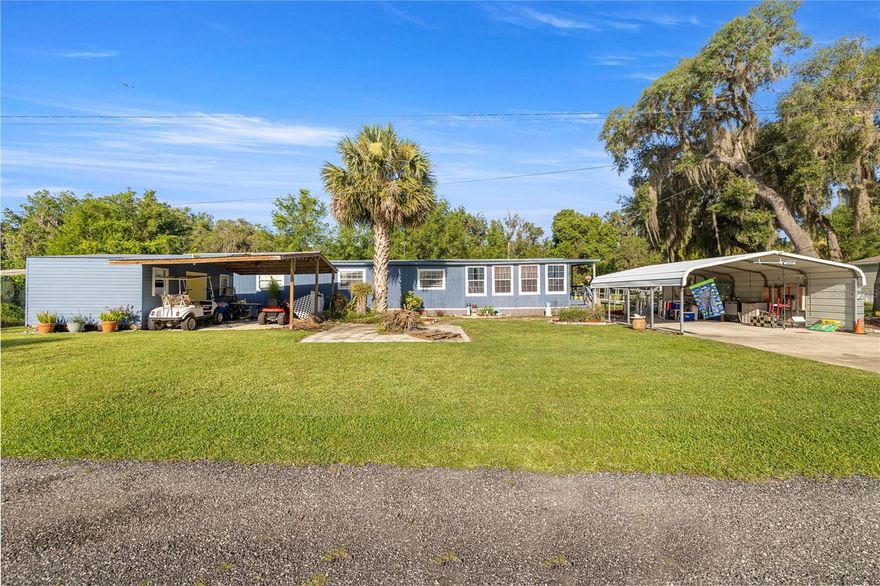 Please read Realtor Remarks for financing options. Welcome to Your Slice of Paradise in Salt Springs! Nestled in the heart of the Ocala National Forest, this beautifully upgraded and expanded home offers the perfect blend of comfort, functionality and Florida charm. Don’t be fooled by its single-wide beginnings—this property has been thoughtfully remodeled and transformed into a spacious and inviting retreat. Step through the covered two-car carport and galvanized ramp into a cozy den, ideal for a home office, TV room, or relaxing hideaway. From there, enjoy a bright and open living and dining area that flows seamlessly into an oversized chef’s kitchen—fully renovated in 2023 with brand-new cabinets, countertops, appliances, and abundant storage and prep space. Gorgeous solid oak flooring adds warmth and character throughout. The bathroom was tastefully updated in 2021, and essential systems have been upgraded for peace of mind, including a new HVAC system (2021), water heater (2021), and durable metal roof for long-term protection. Step out back to your private, vinyl-fenced porch—perfect for sipping morning coffee or unwinding in the evening. The property also features an 16x20 powered workshop/storage shed with a covered overhang, ideal for hobbies, tools, or extra storage. Set on beautifully landscaped grounds, this home is located just one block from the community boat ramp—providing access to stunning Lake George, Florida’s second-largest lake—for only $100/year. Enjoy days filled with boating, fishing, swimming, or exploring nearby trails and springs. Conveniently close to the Salt Springs Marina, shops, restaurants, and more. Whether you're seeking a weekend getaway or a peaceful full-time residence, this well-maintained gem has it all. Motivated seller—schedule your private tour today!