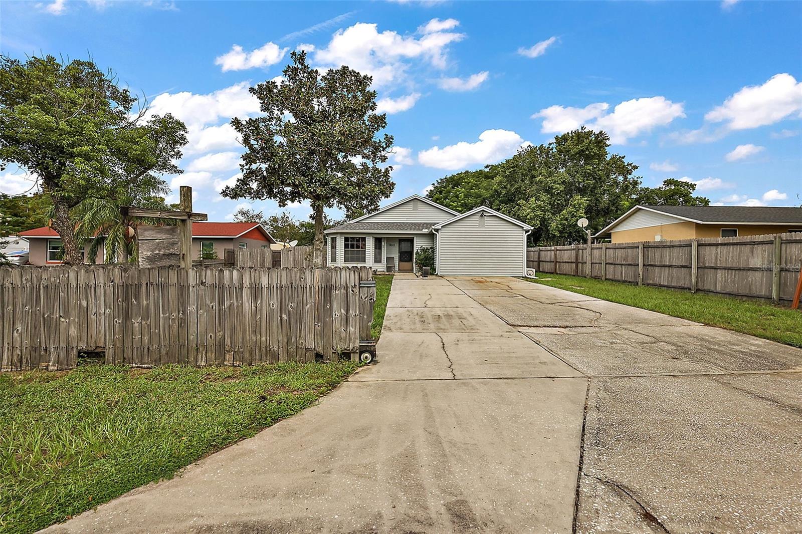 Fantastic First-time buyer or Investment property. New roof in 2023 and 3 year old A/C. This 3 bedroom 2 bath split plan offers a master privacy with an en-suite. Large eat in kitchen with bay window and stainless steel applicances. Partially furnished and featuring a 1 year old roof! NO HOA with a 12 x 24 utility building with electricity that adds extra versatility. Spacoius Florida or Home Office. An easy convert back to a single car garage. While the home could use a little cosmetic TLC, the spacious layout and great room flow make this an excelllent opportunity. Ample parking spaces in the driveway. Convenient to shopping, restaurants, movie theater and medical facilities.