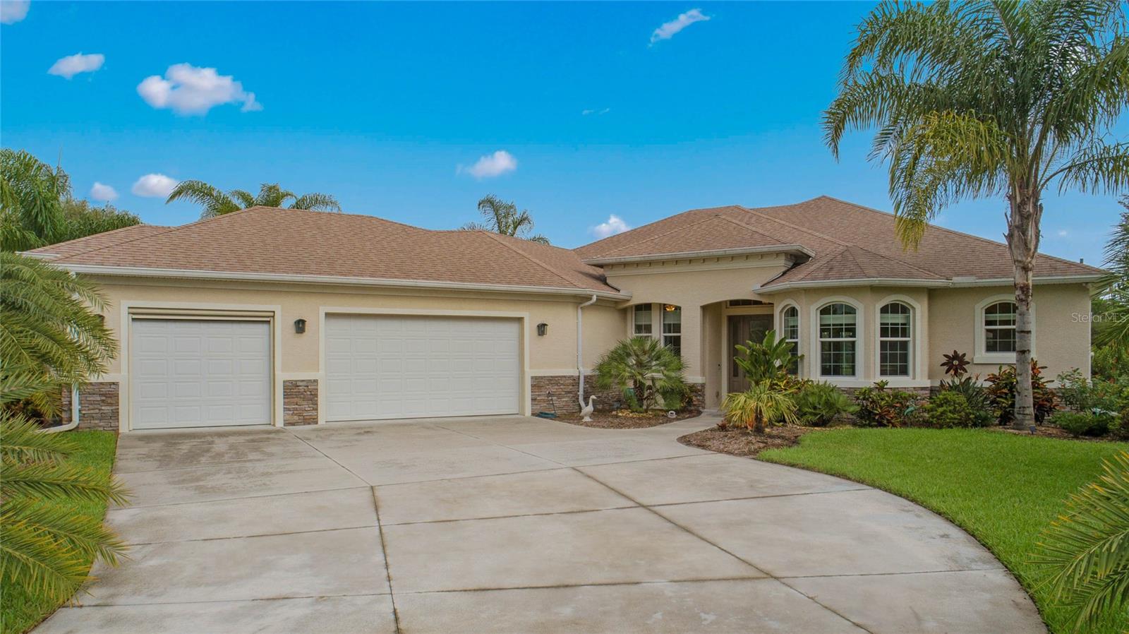 Discover the home you've been dreaming of! This stunning residence is custom built by Solti Homes, and is located in the desirable Halifax Plantation. This home features 3 spacious bedrooms, 2 luxurious baths, and a side-entry oversized 3-car garage, this property sits on a generous ½ acre lot. As you step inside, you're immediately greeted by breathtaking water views, with French doors in the living room leading to a large, screened-in lanai, complete with a private spa area. The open floor plan is thoughtfully designed with split bedrooms and elegant tile flooring throughout. The kitchen is a chef's delight, featuring custom cabinetry from Carter, granite countertops, a large island with a breakfast bar, and a convenient pantry. The primary bedroom is a retreat of its own, offering a spacious ensuite bath with double walk-in closets, a dual vanity, and a large walk-in shower. The additional bedrooms share a Jack and Jill bath. Notable upgrades include: a K-water filtration system, a security system, storm shutters, a garage with over 1000 sq ft, ¼” thick epoxy flooring, a roll-down screen on the single garage, and 10’ ceilings. The home is equipped with a transfer switch and an exterior concrete pad for easy generator setup, along with 5/8” plywood roof sheathing, upgraded ceiling fans, and professional landscaping. Meticulously maintained and move-in ready, this home is located in a vibrant community with amenities such as a golf course, clubhouse, restaurant, tennis courts, community pool, and fitness center. Plus, it's conveniently close to highways, Publix, and shopping. Don't miss out on this exceptional opportunity. Call today to schedule your viewing of this incredible home!