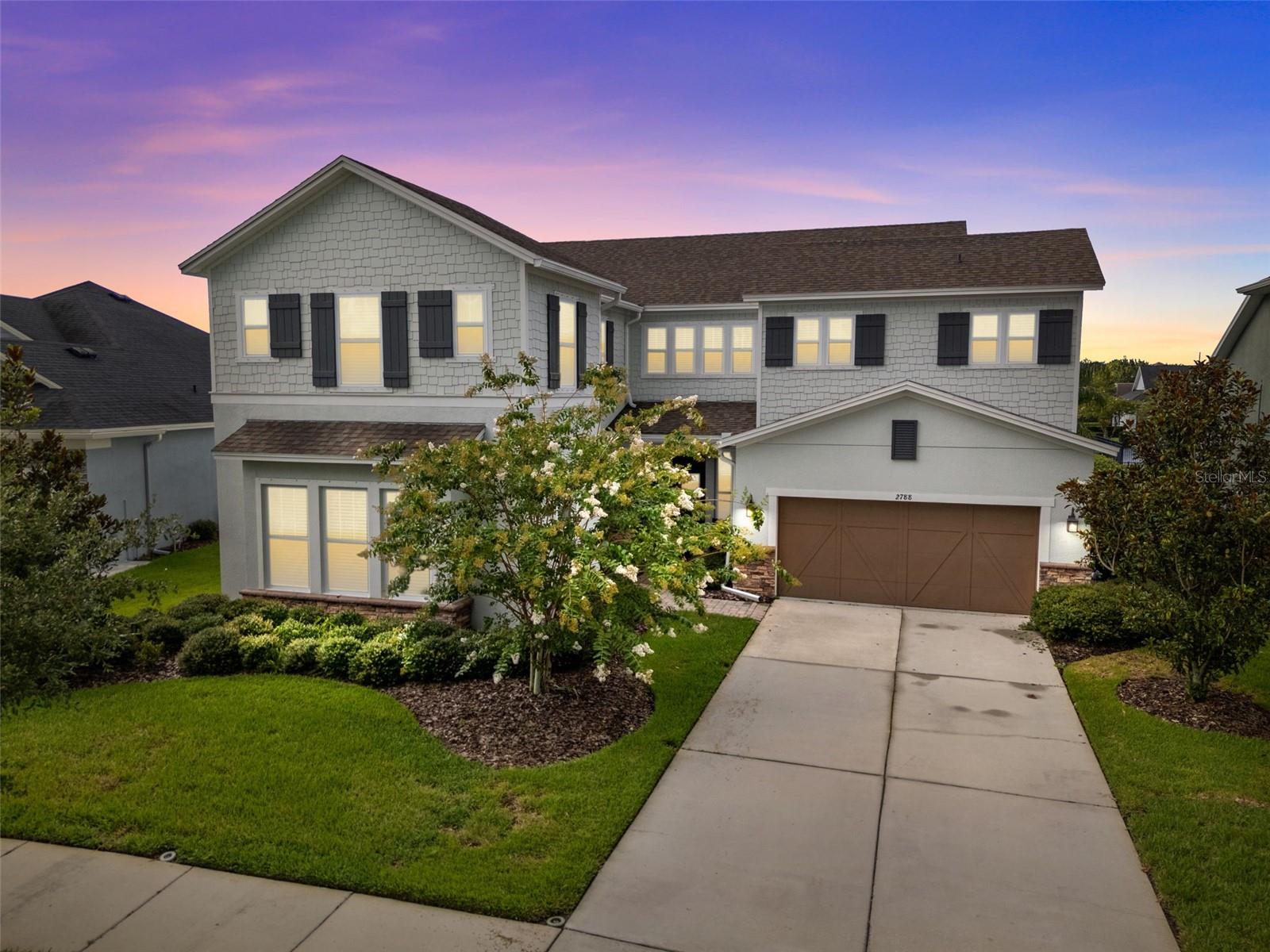 This rare opportunity in Asturia features a true builder-designed in-law suite, a serene pond view, and an oversized 65-foot-wide premium waterfront lot (78' wide lot in the backyard) —offering the ideal combination of functionality, flexibility, and location.
The in-law suite is a standout, seamlessly integrated into the home’s original design with its own private exterior entrance as well as interior access. Spanning nearly 500 square feet, it includes a living room, kitchenette, private bedroom with closet, and full en suite bath.
The main home exudes elegance from the moment you enter, with wood flooring and crown molding throughout. The open-concept layout draws you in with views of the pond straight ahead. The spacious kitchen features white cabinetry, quartz countertops, a large center island, gas cooktop with range hood, built-in ovens, stainless steel appliances, a wet bar area, and a walk-in pantry with custom wood shelving. The kitchen flows into the dining and living spaces, with soaring ceilings and abundant natural light. Triple stackable sliders open to a rear screened-in patio, offering peaceful water views and a perfect space to relax.
Downstairs also includes a laundry room, half bath with exterior access (ideal for a future pool bath), and a two-car garage.
Upstairs, you'll find a versatile loft/media area and a built-in study nook with extended desk space—great for remote work or homework. Four bedrooms are located on this level, including a Jack-and-Jill layout connecting two of the rooms, another bedroom with its own en suite bath, and a luxurious primary suite. The primary bedroom enjoys pond views and includes a spa-like bathroom with dual vanities, an oversized walk-in shower with frameless glass, double shower heads, and a built-in bench. The walk-in closet is fully customized with built-ins for effortless organization. A second laundry room is also conveniently located upstairs. An added bonus is a full house water filtration system.
Set on a quiet street in one of the most sought-after neighborhoods, this home has it all—location, luxury, and livability. Asturia offers resort-style amenities including a clubhouse, pool, fitness center, dog parks, playgrounds, and miles of trails—conveniently located near SR 54 and the Veterans Expressway.
Don't miss your chance to own this one-of-a-kind multigenerational home in Asturia!
