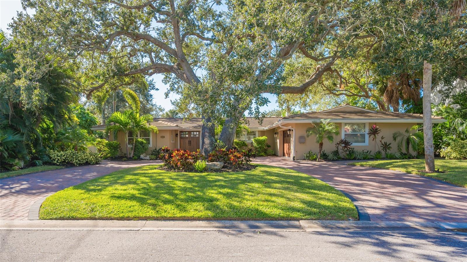 LOCATION,Condition, and Setting on North End of Siesta Key- Both driving on/ off the island and a Boaters dream; 13,000 lb lift for your boat, updated dock, protected 110ft ONE HUNDRED and TEN FEET of protected CANAL FRONT north end Siesta Key, easy deep-water access connects to Grand Canal with one 14-foot bridge clearance to intracoastal waterways and beyond in just a few minutes. This captivating Siesta Key waterfront pool home is on a premium lot, nestled on a serene cul-de-sac. Siesta Key Village shopping, dining and entertainment along with world-famous Siesta Key beach just a short stroll away. The split floorplan provides space and privacy between you and guests. The living room, great room and kitchen are in the heart of the house. The kitchen has solid cabinetry and granite countertops, inviting culinary creations. High-top pass-through bar set up for dining, perfect for entertainment. The primary suite has walk in closet and en-suite bathroom with walk-in shower and dual shower heads, soaking tub, unwind and rejuvenate after a day of exploring the waterways. Step out double glass doors to the pool from your primary suite bonus room /flex space/ den/ fitness room -you decide. Venturing outdoors, discover an expansive patio area for alfresco dining under the newly installed electric pergola perfect for entertaining, canal front with occasional marine life sightings, borders the sparkling pool surrounded by mature lush landscape. Entertaining is easy here, offering a seamless blend of indoor and outdoor living, perfect for hosting memorable gatherings. A spacious backyard area, with ample space for sun-soaked relaxation while the updated docks with lifts for boats and kayaks invite leisurely cruises along the Intracoastal Waterways. Some improvements on home, two AC units, updated docks, lighting, irrigation system throughout, new lined sewer lines, new landscaping with down and up lighting, new paver sidewalks surrounding the entire home, hot water tank, new garage and front door, new pool pump and heater pool deck resurfaced, outdoor kitchen, epoxy garage floor, solar heater for pool. The Florida waterfront lifestyle you have been waiting for has arrived. It's time for more Vitamin SEA and enjoy the famous blue crystalline waters bordering the barrier island of Siesta Key. Downtown Sarasota has dining, shopping, galleries, theater, and opera all just 15-minute drive away! You can have it all!