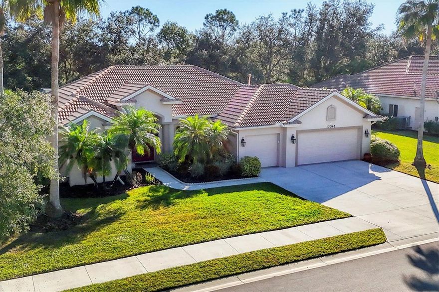 Nestled within the highly sought after gated community of Greyhawk Landing, this meticulously maintained Sam Rodgers quality-built home offers four bedrooms, three bathrooms, a three-car garage, and a heated pool. Designed for both generous spaces and intimate charm, the open-concept layout creates a seamless flow for entertaining and everyday comfort. Expansive glass doors open to a covered lanai overlooking the sparkling pool, outdoor kitchen. The outdoor living space is serene and functional as the indoor with space for entertaining, surrounded by lush palms, landscape lighting, and frequent wildlife sightings capture the essence of true Florida living. The elegant kitchen features custom wood cabinetry and extends into the breakfast area and living room, offering a top designer feel. The owner’s suite provides a relaxing haven with dual walk-in closets, private lanai access, a soaking tub, and dual vanities. Guest rooms are thoughtfully separated for privacy, or flexible den, office for work from home needs. Residents of Greyhawk Landing enjoy resort-style amenities including two clubhouses, lagoon-style pools, fitness center, tennis, pickle ball, basketball courts, playgrounds, soccer, baseball fields, fishing pier on a large lake, and miles of tree-lined walking/biking trails, all within a 24-hour gated community.  Conveniently located near Lakewood Ranch, top-rated schools, shopping, UTC mall, dining, medical facilities,  and the Gulf Coast beaches, this home offers the perfect balance of style, space, and a true Florida lifestyle.