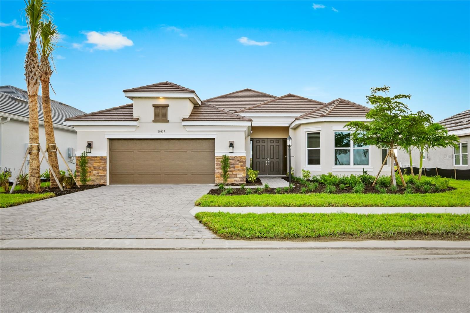 One or more photo(s) has been virtually staged. Located in the world class amenity rich community of Esplanade At Skye Ranch, this unfurnished annual rental is BRAND NEW and is available now. Located on a pond view this Pallazio floor-plan has high ceilings and a wonderful open layout that is designed for flexibility in use and arrangement of furniture. The kitchen has a large island and is surrounded by plenty of cabinets and storage and a walk in pantry. You will enjoy using the gas stove and the awesome serene pond views while prepping a meal or simply relaxing in the family room. The living area has 2 sets of sliders in the family room and kitchen that lead out to the covered and screened 31 foot wide lanai that is 15 feet deep. The spacious primary suite, tucked away at the back of the home, includes an elegant bedroom with direct pond views through the bay window. There are double doors that lead to the beautiful bathroom with dual split sinks, large shower with added shower wand and rain shower head and a private water closet. The walk in closet is very large and measures 15 feet wide and 9 feet deep. Bedroom 2 is perfect for guests, it is en-suite and also has a walk in closet. Bedroom 3 and 4 are on the opposite side of the home and share a full bathroom. The oversized flex room can be used in various ways, the 14-14 size is an excellent space. 2 car tandem garage so the left side is 32 feet deep. Blinds and washer and ndryer and ceiling fans are being added in the next few weeks. Living in Skye Ranch gives you full access to world class amenities and scenic walking and biking trails, and the social and recreational hubs—The Hub, The Venue and Rendezvous Park, and Turner Park. The Hub has a café, indoor basketball and pickleball courts, a rock climbing wall, fitness center, free weights room, exercise studio, kids zone and game room, locker rooms and a Junior Olympic-sized pool, additional community pool, splash pad, separate hot tub, outdoor tennis and pickleball courts, playground equipment, and dog park. Located in the community is The Skye Ranch School for K-6 is now open with plans for future 7th and 8th grade. to get to our world class beaches, simply turn left on Clark Road and drive to Siesta Key Beach and experience unbelieveable sand and the many shops and restaurants in the area.