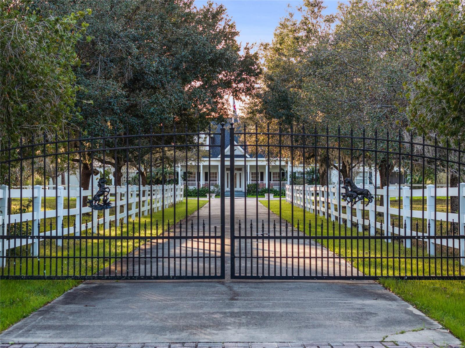 Welcome to an impressive 46.6-acre ranch in New Smyrna Beach, a true haven for horse enthusiasts! Situated in a private gated community just four miles from I-95, this property offers breathtaking views of beautiful beaches. The custom-built main house, crafted in 2000, stands as a masterpiece with five bedrooms, four and a half baths, and a sprawling living space spanning 4,432 square feet. Upon entering, you'll be welcomed by a cozy fireplace, a stunning pool with a spa, and an in-law suite featuring a private entry and screened porch. The main barn, constructed in 2011, is a work of art with six spacious stalls, large runs, automatic waterers, and stall skins. It also includes generous feed, tack, and hay rooms, along with a workshop to meet all your equestrian needs. Upstairs, the barn boasts comfortable living quarters with two efficiencies, a full bath, a kitchen/dining area, a living room, and a bar area. From the viewing deck, you can unwind while enjoying panoramic views of the riding arena and picturesque pasture. The main barn has also served as an Airbnb/horse hotel, providing an income-producing opportunity. The property features a 200-by-100-foot dressage-sized arena and a deeded equine trail within the community. With approximately 31 cleared, fenced, and cross-fenced acres, including a 16-acre uncleared area, this property offers diverse possibilities. Two entrances, one for the home and the other for the barns, enhance convenience. A 40-by-40-foot RV shed with a 20-foot rise, capable of housing farm equipment and horse trailers, is included. Additional amenities comprise a five-stall row barn with automatic waterers, electric, and separate entrances, along with an older barn behind the house, built in 2000, featuring four stalls, tack, and feed rooms. The two-story main house showcases a gas fireplace, large family room, spacious kitchen, game room with a pool table, library, formal dining room, and breakfast nook. The primary suite upstairs includes a garden tub, shower, and dual walk-in closets. The property is complete with a pool, fountain, heated spa, and a 250-gallon propane tank. Experience the Florida equestrian dream by exploring this horseman's paradise today!