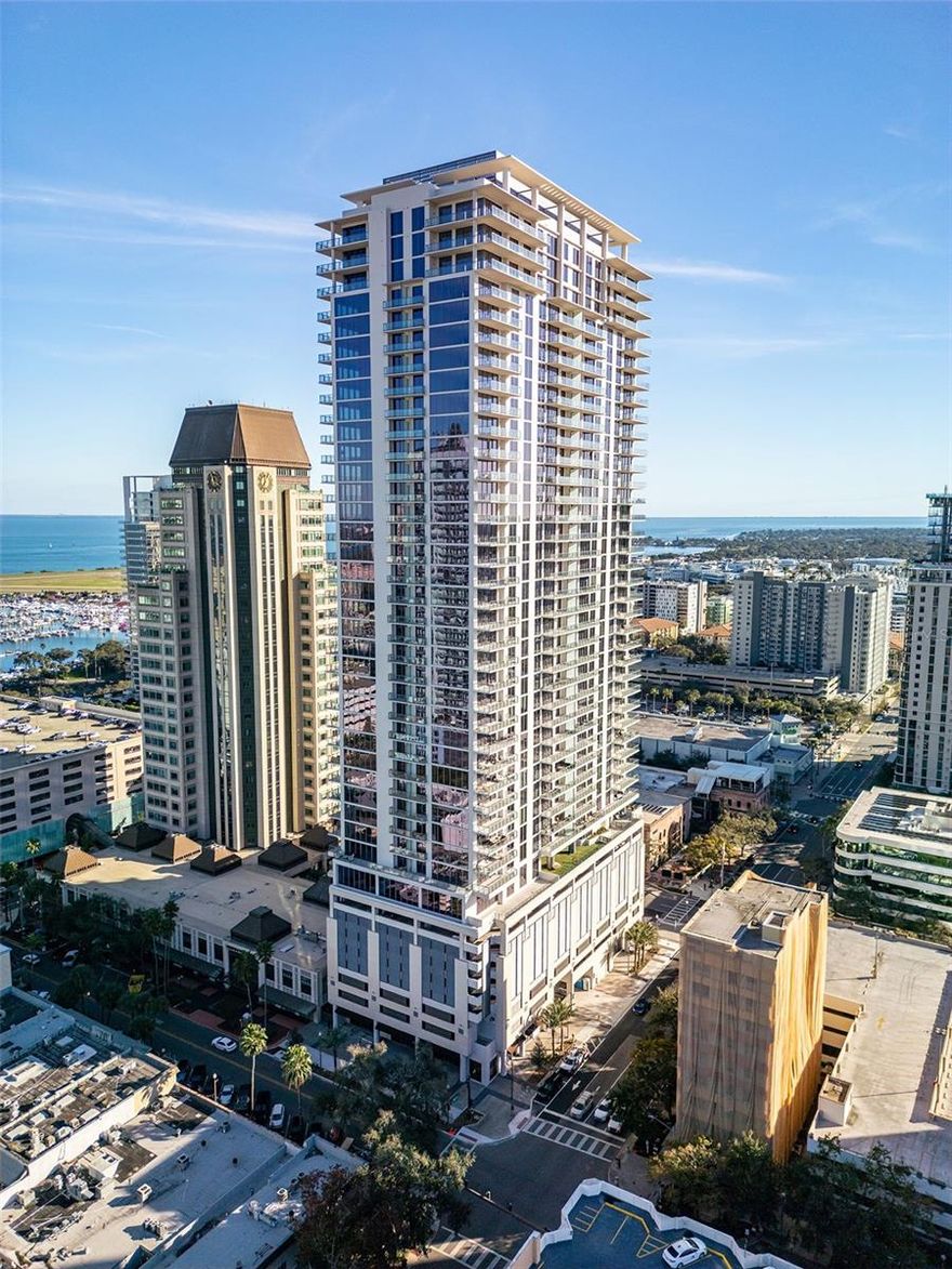 Experience elevated living from the 28th floor at Art House, one of downtown St. Petersburg’s newest and most sought after luxury high rise residences. Unit 2803 offers sweeping city and water views, exceptional natural light, and a refined modern aesthetic designed for those who appreciate quality, privacy, and style. This residence features an open, thoughtfully designed layout with floor to ceiling windows that frame the skyline and bring the outdoors in. The chef inspired kitchen is appointed with upgraded quartz countertops, sleek cabinetry, premium appliances, an induction cooktop, and elevated finishes that were among the highest level of upgrades available at the time of purchase. The space flows seamlessly into the living and dining areas, ideal for both entertaining and everyday living. The den has been fully enclosed, offering flexible privacy and functionality as a third bedroom, office, or media room. The sellers are enhancing the living space further with custom built ins, along with designer chandeliers and upgraded light fixtures that add warmth and architectural interest throughout the home. The primary suite is a serene retreat with expansive views, generous closet space, and a spa inspired bathroom. Every detail has been curated to create a polished, turnkey living experience.
Residents of Art House enjoy a full suite of resort style amenities including a luxury pool and spa, state of the art fitness center, yoga and spin studios, private theater, indoor recreation spaces, massage room, concierge services, secure access, and this unit comes with TWO assigned parking spaces! Located in the heart of downtown St. Petersburg, this Art House places you just steps from world class dining, shopping, museums, nightlife, the waterfront, and the St. Pete Pier, with easy access to Tampa International Airport.