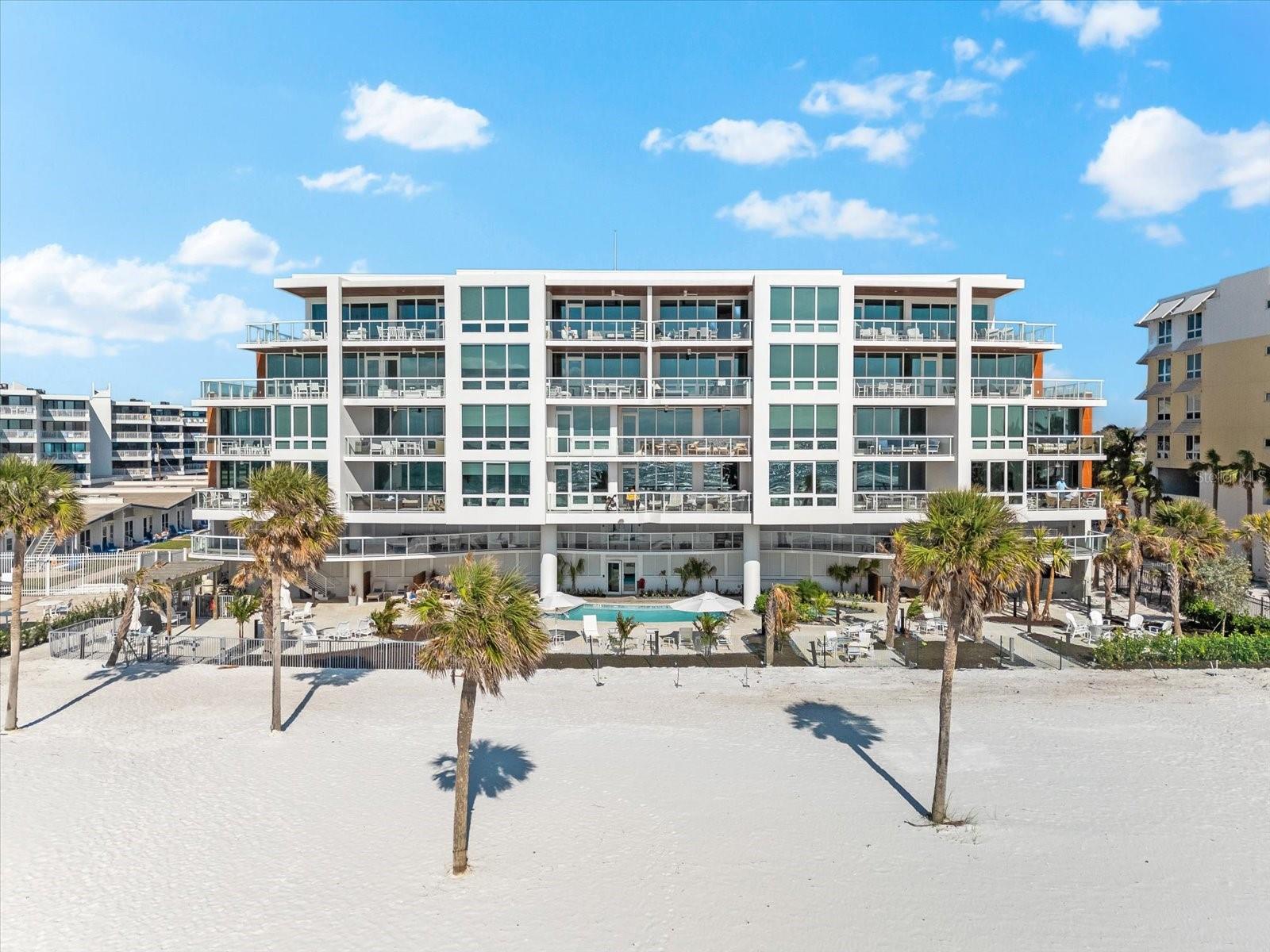 Step into the epitome of luxury living at this exceptional Gulf-front condo, nestled along the serene shores of South Siesta Key. Offering unmatched beach access, this stunning residence is the ultimate seaside sanctuary. Designed with a modern, coastal flair, this spacious 2-bedroom, 2.5-bath home features a thoughtfully laid-out open floor plan, perfect for both relaxation and entertainment. The gourmet kitchen is a chef's dream, equipped with high-end appliances, a wine fridge, and sophisticated finishes. It flows effortlessly into the expansive living and dining areas, which open to a private balcony with breathtaking views. The master suite is a peaceful retreat, featuring a generous walk-in closet and a luxurious ensuite bath with dual sinks, a walk-in shower, and a private water closet. The second bedroom, outfitted with built-in bunk beds, also offers its own ensuite bath, making it perfect for guests or family. This residence is designed to provide both style and practicality, making it ideal for full-time living, a vacation escape, or a lucrative rental opportunity. The building's amenities further elevate the experience, including on-site management for ease of living. Enjoy a beachfront swimming pool and spa, private cabanas, and beachside seating with attentive service. For those who enjoy water activities, complimentary kayaks and paddleboards are available, and additional adventures can be arranged by the concierge. A state-of-the-art fitness center and Gulf-front BBQ area enhance the sense of leisure and community. At Ten35 Seaside, indulge in a lifestyle that blends comfort, luxury, and the peaceful charm of seaside living.