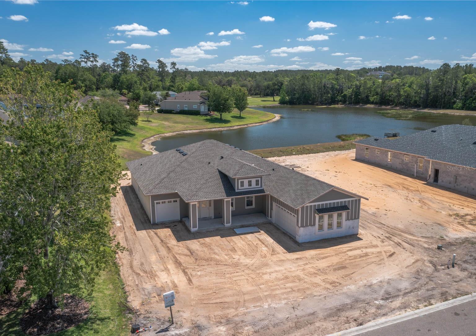 Under Construction. NEW BUILD with CDD fee paid off by the builder, ready in June. Entering the prestigious Southern Hills Plantation golfing community through the manned guard gate you will fall in love with elevation changes unusual to Florida. You feel like you are driving in the rolling hills of Georgia. This Craftsman 3 bedroom with den(4th bedroom or home office) plus split 3 car garage is laid out perfectly over 1 story with high ceilings. Entering the home you are greeted with the highly sought after open floor plan of an EXTRA LARGE living room (with tray ceiling), dining room, and kitchen. The chef's kitchen features a gas cooktop with hood, built-in convection oven and microwave, soft close real wood white shaker cabinets, quartz countertops, large island with breakfast bar seating, subway tile backsplash, and under cabinet lighting. The home also has a split floor plan with the master retreat featuring a tray ceiling, 2 walk in closets, his/her vanities, and separate soaking tub. The home has many upgrades including 8 foot doors, luxury vinyl flooring in all common areas, subway tile backsplash, detailed baseboards, quartz countertops, tray ceilings, shower enclosure, tankless gas water heater and just too many more to list. Tons of covered outdoor space including a long front porch. Then 1 long covered back porch makes an entertainer dream plumed for an outdoor kitchen overlooking a pond. You will never have a neighbor behind your lot overlooks a pond. The community has a resort style pool, fitness center, Har-Tru tennis courts, pickleball courts, walking trails, and a Tiki Hut restaurant that will be completed this summer. Pete Dye fell in love with the elevation changes ranging from 60 feet to almost 250 feet here at Southern Hills. The private world-class track is rated by Golf Week as a top 100 residential course in the United States. It even features practice facilities of a driving range, chipping/putting greens, and a 6 hole par 3 course. Located just off 41 and the Suncoast Pkwy, you can get to Tampa International Airport and Raymond James Stadium in just 45 minutes. No CDD fees as the builder paid off the entire bond saving you THOUSANDS over the years, just a small O & M annual fee. Come see why everyone is choosing to live and play in the luxurious gated Southern Hills!