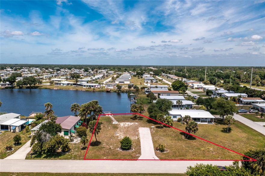 Discover the opportunity to live your Florida dream in Lemon Bay Isles, a welcoming 55+ community where every day feels like a getaway. This prime lakeside lot with a private dock has already been cleared and prepped with paid power, water, and sewer connections, plus a driveway and slab ready for your new manufactured home. As a golf cart and pet-friendly neighborhood with no monthly maintenance fees, residents enjoy both convenience and freedom. Membership to The Edgewater Club is available at a low annual cost, giving you access to a clubhouse filled with activities, a lakefront pool, tennis and pickleball courts, shuffleboard, bocce ball, and a calendar full of weekly music, monthly dinners, and social gatherings. Just minutes from Englewood Beach, local tiki bars, waterfront dining, shopping, and endless outdoor recreation, this is the perfect setting for an active and relaxed coastal lifestyle. Now is the time to secure your place in this community and start living the Florida lifestyle you’ve been dreaming of.