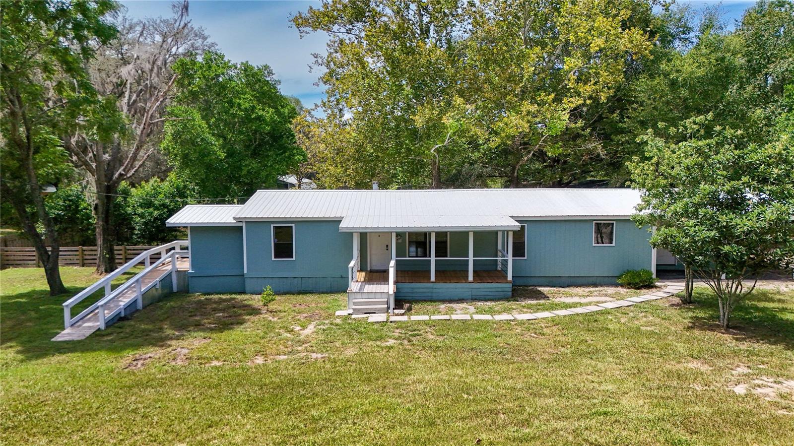 Welcome to the Peaceful town of Dunnellon! This 3-bedroom, 3-bathroom home sits on 2.24 acres and is zoned for horses, featuring double fencing, a barn, and a large studio barn apartment, perfect for equestrian or multi-use living. Recent updates include brand-new flooring, fresh interior and exterior paint, a new HVAC system and new water heater for your peace of mind. Metal Roof on all buildings. Front and rear porch for sitting outside and enjoying the pristine property. one enclosed porch to stay out of the weather. The property also offers 2 RV hookups, making it ideal for guests or travel enthusiasts. With room to roam and endless possibilities, this unique property combines country living with modern comfort. Minutes from then crystal clear Rainbow River State Park and Natural Springs or enjoy the best fishing in Florida on nearby Lake Rousseau. Not a water person, there is hiking, bicycling and horse back riding on the Withlacoochee Trail or Goethe State Forest. WEC (World Equestrian Center) 16 miles from property 22 minute drive. Quiet country setting close to shopping, restaurants, and entertainment. Come make this your dream home!!!!