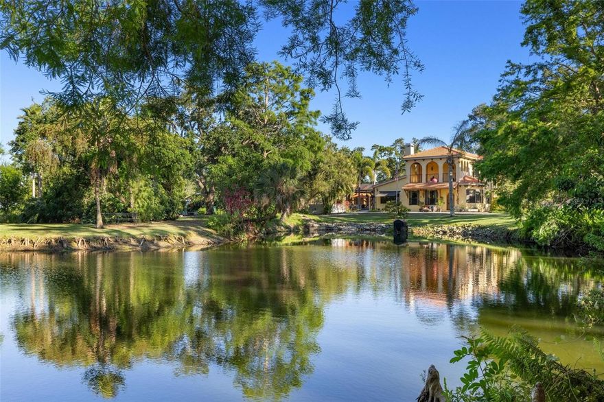 AN EXQUISITE 3 ACRE ESTATE IN THE HEART OF SARASOTA WITH MAIN RESIDENCE AND GUEST HOUSE. Behind a rustic hand crafted door door lies a world of timeless elegance and inspired living. Nestled on approximately 3 acres next to a protected preserve, this captivating estate blends Old World charm with Florida's natural beauty to create a truly one-of-a-kind retreat. Every corner tells a story—crafted with unique architectural elements, curated antiques, and artistic touches that evoke the feeling of a European villa.

From the moment you enter, you're greeted with warm, inviting spaces designed for both quiet reflection and joyful entertaining. Inside, a chef's kitchen, a pizza oven, and multiple dining areas are designed for memorable gatherings, while themed rooms and intimate spaces provide moments of delight and discovery. The primary suite is situated on the upper level and offers a luxurious escape, complete with spa-like features and private outdoor access.

Outdoors, explore tranquil gardens, a peaceful lake, mature trees, and thoughtfully designed areas for dining, gathering, and relaxation. A covered portico connects to an impressive pool and entertaining area, anchored by an outdoor fireplace and a fully equipped kitchen—perfect for alfresco dining and sunset soirees. Whether hosting a grand celebration or enjoying a quiet evening under the stars, the outdoor spaces are designed for unforgettable moments.

A detached workshop, multiple garages, and whimsical retreat spaces add to the estate's versatility and charm. The MLS square footage does not include the guest house (1,377 sq ft additional) or the charming cottage—each offering flexible options for guests, extended family or creative space.