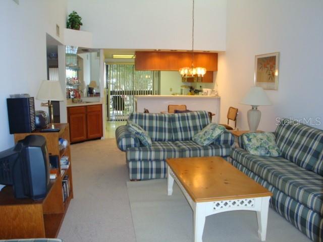 Short term furnished rental condo. Woodlake Run of East Lake Woodlands Country Club Community.......... Vacation in Florida in this second floor condo with vaulted ceilings and wonderful view of pond. You will find living room/dining room combination with sliders out to screen enclosed lanai and breakfast bar to the tiled kitchen area. Sliders off kitchen where washer and dryer are located in the utility closet. Split bedroom plan with king bed in the master bedroom (plus flat screen tv) along with sliders out to lanai and twin beds in the guest bedroom (with small tv) also with sliders out to an open patio. Shower only in guest bath, tub/shower combination in master bath. This is a non smoking unit. Community heated pool nearby. Water, sewer, trash, basic cable, internet, local phone service and up to $100 per month of electric is included in the rent. All short term rates are subject to 13% sales/tourist tax. Please call for availability.