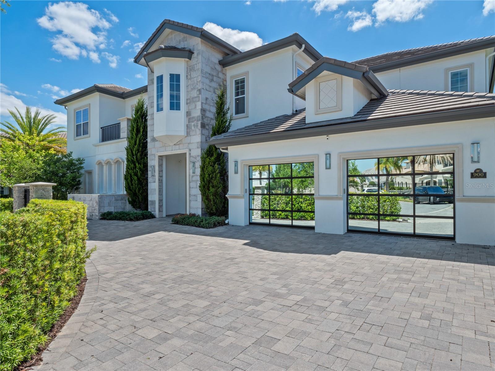 Discover the epitome of custom LUX Living at 900 Jack Nicklaus Ct, nestled in the prestigious Reunion Resort, known for its world-class amenities and breathtaking views. This stunning home offers a perfect blend of elegance and comfort, ideal for both family living and entertaining. This custom home is built on two oversized homesites and offers expansive views down the 18th hole of the Jack Nicklaus Signature golf course.
As you enter this beautifully appointed home, you are greeted by a 24’ expansive foyer that radiates warmth and style. The spacious living area is adorned with chic furnishings, making it the perfect spot to unwind after a day of exploration. The adjoining modern kitchen, equipped with top-of-the-line appliances, invites you to whip up culinary delights while enjoying quality time with loved ones. This Bears Den custom home boasts 8 elegantly designed bedrooms, each offering a tranquil retreat with plush bedding and walk in closets. The en-suite bathrooms feature luxurious fixtures and finishes, ensuring a spa-like experience during your stay. So much fun under one room, from enjoying watching movies and eating popcorn STARLITE ceiling Movie room with theatre seating to the full golf simulator and entertainment area. This spectacular home also boasts its own indoor SPA with waterfall jacuzzi, rain forest shower and dry sauna, perfect body nurturing after a long day at the parks or golf course. Step outside to your private oasis, where your sparkling infinity edge pool & hot tub awaits, surrounded by lush landscaping. The massively oversized outdoor space is perfect for sun-soaked afternoons, evening barbecues, or simply enjoying the Florida sun in style. Your oversized covered lanai is perfectly situated offering a chefs summer kitchen and outdoor entertainment. The lanai even offers built-in infrared heaters for any cool central Florida nights.. Reunion Resort is renowned for its luxurious lifestyle and is conveniently located near major attractions, shopping, and dining. Experience the charm of resort-style living while being just a short drive from the excitement of Orlando. This property is also ideal for short-term rentals, making it a fantastic investment opportunity in a high-demand vacation destination. Schedule a private showing today to experience all that this remarkable home has to offer and explore other homes part of our Luxury Collection here at Reunion Resort.