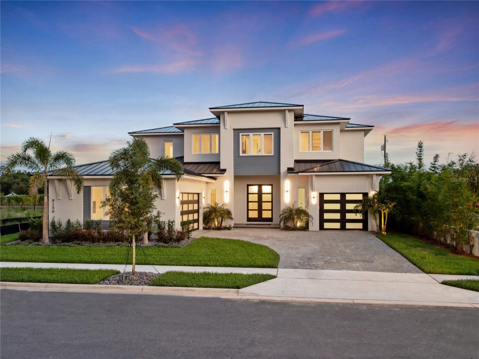New Construction. MODEL OPEN – VISIT US TODAY. Introducing the Sunscape by Element Home Builders, located in Windermere’s newest luxury community, Lake Sheen Sound. This stunning custom home offers a spacious 5,232 square feet layout with six bedrooms and five and a half bathrooms. Situated in the Windermere area, Lake Sheen Sound offers residents a serene lakeside lifestyle just minutes from top-rated schools, fine dining, upscale shopping, and major highways for easy access to Orlando’s best attractions. Enjoy the perfect balance of privacy and convenience in this meticulously planned community. The welcoming entryway provides immediate views of the sizable lanai and pool area. The open floor plan features a gourmet kitchen with a large kitchen island and walk-in pantry with ample storage. Adjacent to the kitchen, the formal dining room is ideal for entertaining large groups. The great room leads to the primary suite, which includes a seating area and a luxurious spa-like bathroom with a soaking tub and a large, beautifully tiled shower. The extensive walk-in closet has custom built-in features and plenty of additional storage. Upstairs, there are four spacious bedrooms with ample closet space, two full bathrooms, and a Jack and Jill bathroom. A centrally located game room offers plenty of space to entertain, host movie nights, or enjoy games. Outside the lanai, an impressive outdoor dining area provides the perfect setting for warm-weather entertaining. A powder room accessible from the lanai adds convenience. The outdoor space is completed by a sparkling heated pool and paver deck with open views. This exquisite home includes two separate garages, one for two vehicles and another for a single vehicle. A mudroom off the garage adds extra convenience. Lake Sheen Sound by Element Home Builders is a meticulously planned community of 14 exclusive homes, including three generously sized one-acre lakefront homesites and 11 interior lots. The lush landscaping provides a scenic, private setting designed for the utmost luxury and comfort.