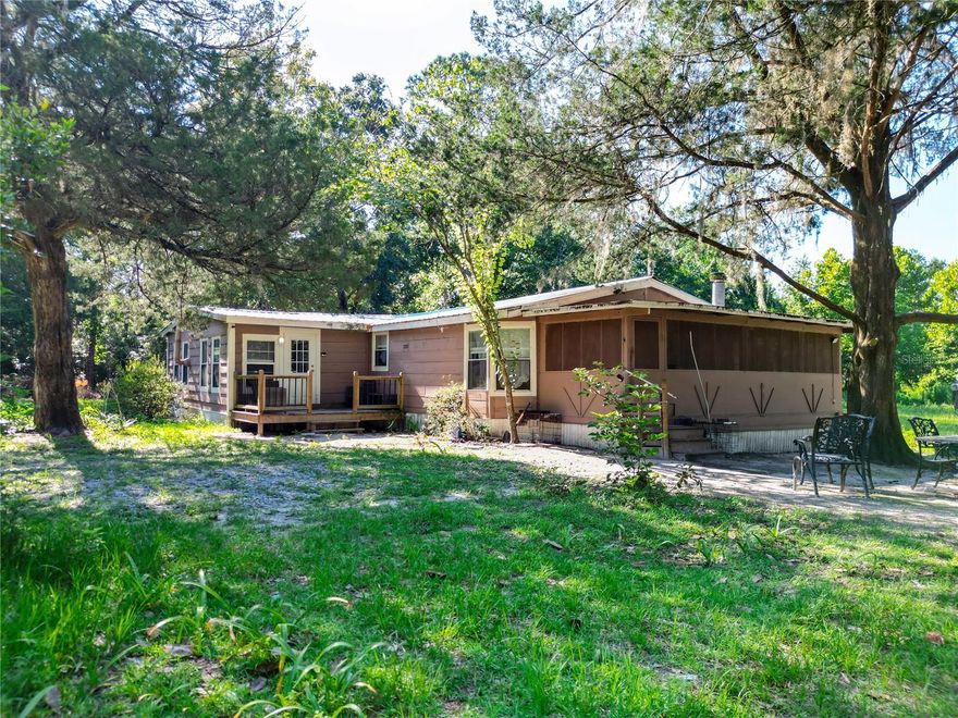 AMAZING OPPORTUNITY IN THIS PRIVATE 9.8-acre FARM! Backing up to the state forest, it offers all the peace and natural beauty you’ve been looking for. The 3-bedroom, 2-bath home (about 2,000 sq ft) includes two comfy living rooms, a fireplace, wood-burning stove, a big dining area, and a spacious kitchen with an eat-in bar—plenty of room to spread out. Step outside and you’ll find a shooting range, a 24x40 pole barn, and a massive fire pit perfect for hanging out with friends and family. The land is full of character, with magnolias, cedar trees, bamboo, and more. The home also features a metal roof, screened-in mudroom, and a custom front porch to enjoy the views. You’ve got propane cooking, central A/C, and plank flooring for everyday comfort. Conveniently located near Bronson and Williston, and not far from Ocala or Gainesville. Whether you're into hobby farming, outdoor fun, or just want some breathing room, this place has you covered. There’s no HOA, taxes are low, and the home’s move-in ready. Make it yours—come see what peaceful country living in Levy County feels like!