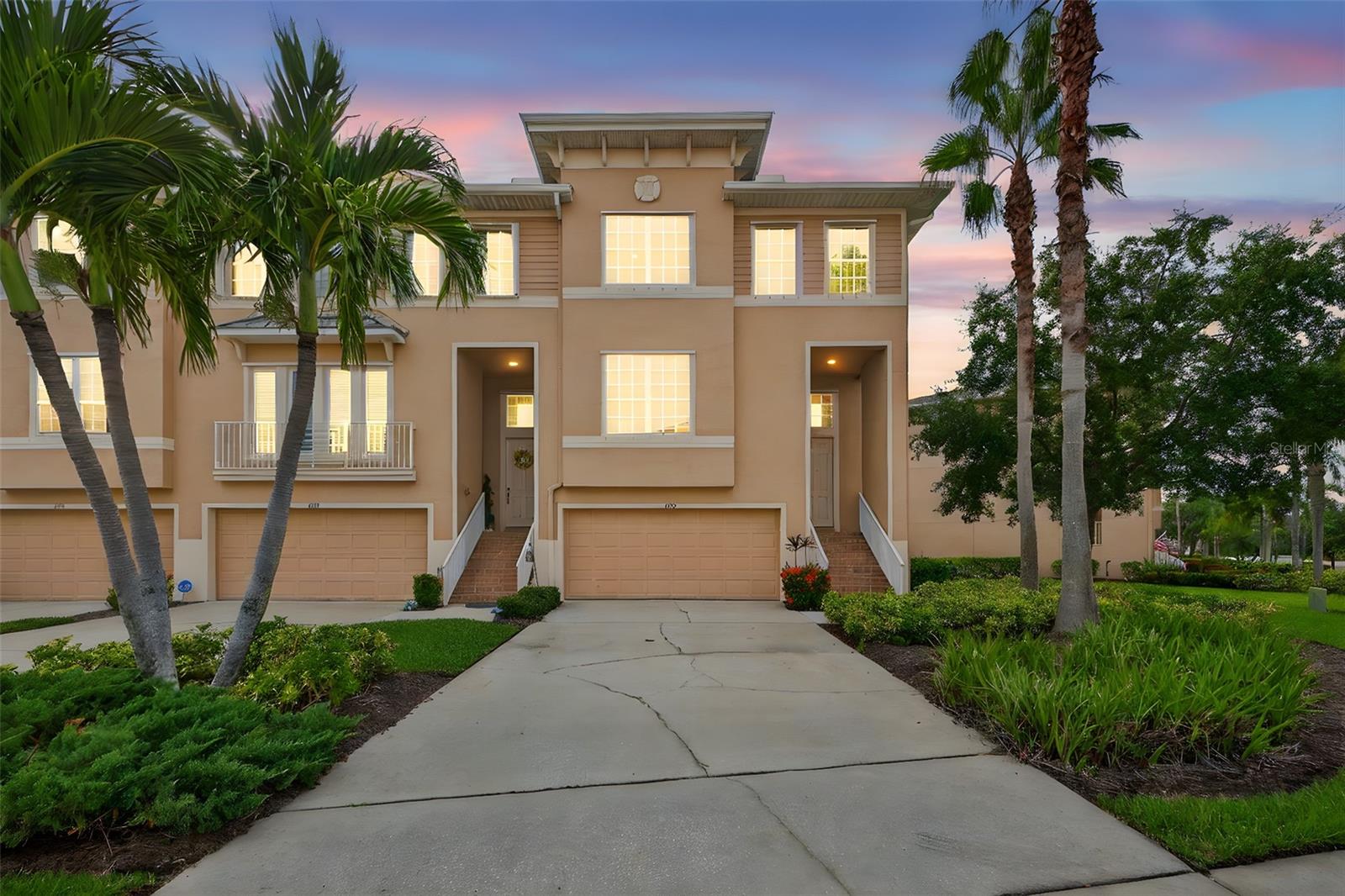 Welcome to Seminole Isle, an exclusive gated community offering resort-style living just minutes from everything you love about Florida’s Gulf Coast. This beautifully updated corner end-unit townhome offers a coastal vibe with a light and bright atmosphere enhanced by an abundance of natural light throughout. At the heart of the home, the spacious kitchen and open living area set the stage for both everyday comfort and effortless entertaining. The kitchen features stone countertops, stainless steel appliances, a walk-in pantry, built-in desk, and abundant storage. A casual bar counter and sunny eat-in nook invite friends and family to gather, while the open layout flows into the expansive living room. Here, sliding glass doors extend your living space to the screened lanai with tranquil water views—perfect for morning coffee or evening cocktails. You will enjoy gorgeous sunset views every evening from your screened lanai. The adjacent formal dining room, also with lanai access, makes hosting dinners a true delight. Upstairs, a versatile open loft provides the perfect spot for a home office or reading room. The enormous primary suite feels like a retreat, offering a spa-inspired ensuite bath with a garden tub, separate shower, dual vanities, and a large walk-in closet. The upstairs also includes a convenient laundry room with cabinetry, two additional bedrooms, and a guest bath. The oversized garage is a rare find, accommodating 3–4 vehicles depending on size. Step out the back door to another covered lanai overlooking a peaceful pond and fountain—your own private oasis. The end unit offers a larger green space between buildings. Beyond your front door, Seminole Isle offers an unbeatable location. Just across the street, Lake Seminole Park features 250 acres of trails, picnic areas, and a boat ramp. Shopping and dining are minutes away at Seminole City Center, where you’ll find Publix, HomeGoods, Target, Studio Movie Grill, and popular restaurants like Outback Steakhouse, Miller’s Ale House, and Craft Street Kitchen. Beach days are just minutes away! The world-famous Gulf Beaches are only 10 minutes away. Inside the gates, Seminole Isle residents enjoy resort-style amenities including a sparkling pool, fitness center, clubhouse, tennis and pickleball courts, a kayak launch with dedicated kayak storage, community BBQ and firepit areas, scenic walking paths, and a private boardwalk surrounded by natural beauty. Seminole Isle is a private, and luxurious townhome community offering resort style living!!