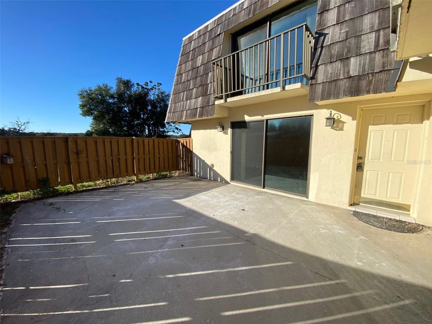 AFFORDABLE home with NEW flooring, NEW roof and a MOTIVATED SELLER.  Gated community with POOL, FITNESS CENTER and CLUBHOUSE. Lets make a deal! This home needs a deep cleaning (see photos) and absolutely needs interior paint so here is your chance to cut a deal and build some sweat equity. If you don't have time or the desire to deal with that, no worries, add $600 to offer for cleaning and or $2500 to paint and we'll have you all set by your move in date. This is a block constructed townhouse with 2 bedrooms upstairs each with their own private en-suite bath. Also each bedroom has a set of sliding glass to their own balcony overlooking your private courtyard and one of these bedrooms has view of pasture behind community where you will see cattle roaming around. Kinda cool. Downstairs is the living room with sliding glass doors to the courtyard and there is another set of sliding glass doors at the kitchen. There is also a half bath downstairs for guests or convenience. All appliances including washer and dryer are included and you never need to drive around endlessly looking for a parking space because you'll have two reserved spaces. Call to see this home TODAY.