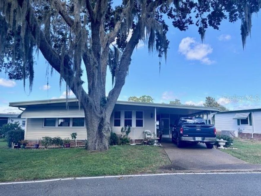 This charming fully furnished home sits on a corner lot with a pea gravel driveway and a covered carport, offering great curb appeal and easy access. Inside, you'll find a comfortable layout with a dining area that flows into the kitchen and living spaces. The Florida room is fully enclosed and climate-controlled, making it a perfect spot to relax or entertain year-round. The master bedroom features a walk-in closet and plenty of space for your furniture and personal touches. Other highlights include built-in cabinetry, ceiling fans, and a peaceful yard shaded by mature trees....... Hawthorne at Leesburg is an active, resident owned, 55+ cooperative, waterfront, gated community, with beautifully landscaped grounds, lakes with illuminated fountains and a relaxing and comfortable gazebo. The affordable monthly maintenance fee of $346 includes water, sewer, lawn mowing, private emergency services and storage space for recreational vehicles, boats, trailers and much more! The beautiful clubhouse is complete with a full-time program coordinator, more than 100 different activities and seating for 550. It has a hospitality lounge, card rooms, craft rooms, billiard room, fitness center, library, fine arts room and many more. There is excellent fishing, outdoor geo-thermally heated pool and two enclosed therapeutic pools. Hawthorne boasts a private marina monitored by an electronic security system with over 120 boat slips and access to the Harris Chain of Lakes and beyond.