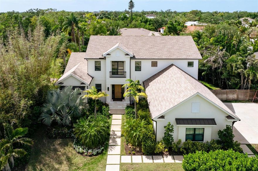 Experience refined modern living in this Oyster Bay Estates, stunning five-bedroom, four-and-a-half-bath residence thoughtfully designed and custom built with exceptional craftsmanship, elevated finishes, and sophisticated smart-home technology. Every detail of this home reflects a commitment to quality, comfort, and luxury. The heart of the home is an extraordinary chef's kitchen appointed with top-of-the-line Thermador appliances, custom cabinetry, an expansive island ideal for entertaining, and a striking custom hood. Elegant designer lighting and Emtek hardware compliment the home's extensive custom woodwork, including solid interior doors, crown molding, baseboards, and detailed window casings. Rich hardwood flooring flows throughout the living spaces, enhancing the home's warm yet refined aesthetic. Designed for both entertaining and everyday enjoyment, the home features a temperature-controlled 120-bottle wine cellar with WhisperKool system, a dedicated golf simulator room with Foresight simulator, and multiple thoughtfully designed living spaces. Smart-home technology is seamlessly integrated through a Wicked Smart system, controlling lighting, sound, security, shades, and WiFi, along with a Lutron automated lighting system throughout. The large and private outdoor living spaces are equally impressive, featuring a custom outdoor kitchen with integrated sound system, a resort-style pool and spa with sun shelf, and elegant travertine pool decking, creating the perfect setting for relaxing or entertaining under the Florida sun. Additional highlights include a striking custom solid oak entry door, designer-selected tile throughout, a built-in Elkay water dispenser, two laundry rooms for added convenience, landscape lighting and a spacious three-car garage. A rare opportunity to own a meticulously designed luxury residence where timeless craftsmanship, cutting-edge technology, and exceptional amenities come together in one remarkable Sarasota home.