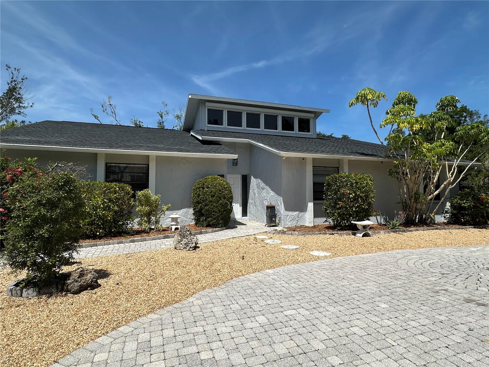 Siesta Key Custom Pool Home, Vaulted Ceilings and Skylights- Architectural Gem.
Welcome to 733 Tropical Circle — a custom-designed retreat tucked away in the heart of Siesta Key. This 3-bedroom, 2-bathroom home offers a unique blend of natural warmth, architectural character, and relaxed coastal charm.
Step inside to soaring ceilings with skylights and stunning wood accents that fill the living spaces with light and serenity. The open floor plan features a grand stone fireplace, expansive living room, and a spacious kitchen with bold, modern cabinetry and sleek finishes.
Out back, enjoy your own private oasis — a fully screened-in pool and covered patio surrounded by lush landscaping. Pool and lawn care are included, making this home as easy to maintain as it is to enjoy.
Additional highlights:
- Master suite with walk-in closet and private bath
- Oversized laundry room with extra storage
- 2-car garage and smart organizational spaces throughout
- Peaceful, low-maintenance landscaping with a circular paver drive
Minutes from the beach, yet tucked into a quiet residential street — this home is ideal for anyone seeking style, functionality, and island ease.