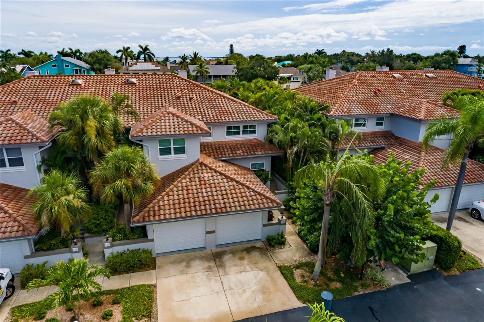 Experience the ultimate Florida lifestyle in this beautifully remodeled solid block construction, end-unit waterfront townhome in desirable Tierra Verde. Offering over 1,750 square feet of light-filled living space, this rare property includes a deeded boat slip with a 20,000-pound lift just steps from your back deck. The setting combines end-unit privacy, lush tropical landscaping, and sweeping canal views where dolphins and manatees glide past your dock.
Enter through a private courtyard with only five steps up into the open plan designed for luxury and comfort. The chef’s kitchen boasts breakfast bar, waterfall-edge quartz countertops, custom cabinetry, GE Profile appliances, Monogram induction cooktop, convection oven, three-door refrigerator, and wine cooler. A stylish bar flows into the dining area, while the living room features a modern fireplace framed by impact-rated sliders opening to a sunroom, deck, and dockside patio. Indoor-outdoor living is seamless, perfect for entertaining with a steak grilled on the upper deck or sunset cocktails or morning coffee on the waterfront patio.
This home was recently gutted to the concrete blocks & redone by a renowned interior designer with every nook & cranny beautifully appointed including an extremely efficient Home Office with built in cabinetry to hide your office peripherals. The dedicated home office with custom built-ins offers a quiet, efficient space for remote work or managing personal affairs. Upstairs, two ensuite bedrooms include a luxurious primary suite with water views, plantation shutters hiding blackout shades, and a spa bath with dual vanities, soaking tub, frameless glass shower, and custom closet. The guest suite provides comfort and privacy, while a full laundry room completes the second floor.
Designer finishes include travertine marble and wood flooring, tongue & groove ceilings, plantation shutters, recessed LED lighting, and motorized shades. Upgrades provide peace of mind: PGT impact-rated windows & doors, electric storm shutters, new water heater, water softener with filtration, a new A/C system with all-new ductwork and a Ring Doorbell. With a very high elevation, the property has never experienced flooding or storm damage.
The oversized one-car garage features a wind-rated door, overhead storage, and direct kitchen access. Waterfront living extends outdoors with your private dock and lift, a kayak launch with storage, and an inside fishing-rod closet. Community amenities include a heated pool and spa. HOA fees cover exterior maintenance, landscaping, cable, streaming, internet, water, sewer, and trash, allowing for true lock-and-leave living.
Tierra Verde is renowned for its island lifestyle with marinas, dining, and recreation nearby. Fort De Soto Park, St. Pete Beach, Pass-a-Grille, and downtown St. Petersburg are minutes away, with Tampa International and St. Pete-Clearwater airports quickly accessible by I275.
This rare end-unit combines the privacy of a single-family home with maintenance-free living. Featuring a deeded dock and lift, custom home office, and the option to purchase furnishings for an additional fee, it represents one of the finest opportunities in Tierra Verde today.
