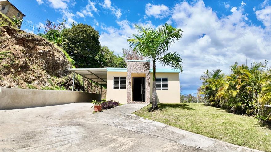 Located in the charming and authentic neighborhood of Barrio Cruces in Rincón, this cozy 3-bedroom, 2-bath single-family home offers comfort, privacy, and everyday convenience in one of Puerto Rico’s most desirable beach towns. Priced to sell, this property presents an excellent opportunity for families, newcomers to the area, or buyers looking for a well-located home with value and potential. The property sits on a natural bluff, allowing for refreshing island breezes and an elevated outdoor setting. The outdoor patio provides a great opportunity to create your own retreat, with space suitable for a small plunge pool, garden seating, or outdoor lounge area to enjoy Rincón’s relaxed lifestyle.
Situated on a quiet dead-end road, the home offers a peaceful residential setting while remaining just a short 7-minute drive to Rincón’s beaches and town plaza. The practical layout includes 3 bedrooms and 2 bathrooms, a carport for two vehicles, a dedicated laundry room, and a fully fenced yard ideal for privacy, pets, or outdoor enjoyment.Additional features include a septic system and a transfer switch installed for generator connection, adding convenience and preparedness. Barrio Cruces is known for its local charm and friendly residential atmosphere, with bakeries, hardware stores, and everyday amenities nearby, making daily living easy while still enjoying the laid-back lifestyle that makes Rincón so special. Whether you're looking for a comfortable primary residence, a cozy home to relocate to Rincón, or a well-priced opportunity in a desirable zip code, this property offers a welcoming place to settle in and make your own.