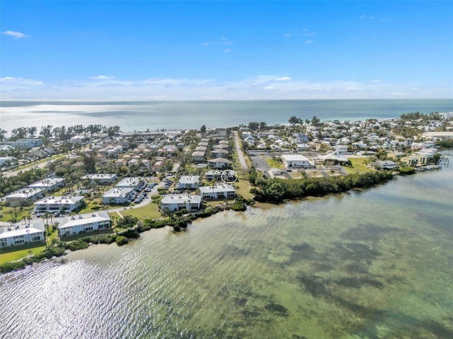 First-floor corner unit with amazing bay views in the waterfront community of Westbay Cove on Anna Maria Island. This 2 bedroom, 2 bathroom condo offers a bright, functional layout with abundant natural light and peaceful views of the bay. The kitchen features custom cabinetry, tile backsplash, and newer appliances, and opens to the main living area and enclosed Florida room. The Florida room adds additional living space and is the perfect place to enjoy morning coffee while taking in the bay breezes and sunrise skies. The primary suite includes a walk-in closet, private sliding-door access to the Florida room, and an updated en suite bath with a quartz vanity and tile flooring. The guest bedroom is generously sized with dual closets and an ensuite bathroom featuring quartz countertops and a custom tiled shower. The guest bedroom also has private access to the screened front lanai. Additional features include hurricane-rated windows (sliders are not hurricane-rated), updated flooring, and a new stackable washer and dryer in the screened front lanai. The unit is being sold turnkey furnished, making it move-in ready for seasonal use, full-time living, or investment. Westbay Cove is a well-maintained bayfront community on Anna Maria Island offering two pools and beautifully landscaped waterfront grounds. Located just minutes from Anna Maria Island beaches, restaurants, and shopping.
