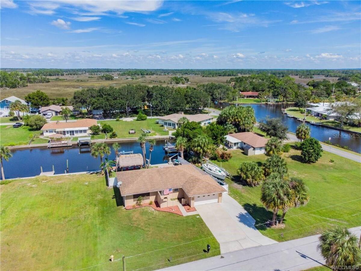Beautiful 2 bedroom, 2 bathroom home (easily converted to a 3/2) located on the Salt River/Dixie Bay, offering direct access to Crystal Bay, the Gulf of Mexico, and a short boat ride to Crystal River’s freshwater springs. Enjoy stunning views and nearby nature trails at Crystal River Preserve State Park. This home has been completely renovated, featuring an updated kitchen and bathrooms, tile and vinyl plank flooring, built-in doggie doors, AC, hybrid hot water heater, energy-efficient windows, and a security camera system for peace of mind. The outdoor space is ideal for entertaining and relaxing, with a vinyl fence, deck, paver patio, and a 10' x 16' tiki hut. Boaters will appreciate the 10,000lb boat lift, and wildlife lovers can watch dolphins, manatees, and fish right from the backyard. This home also includes a private movie theater room for cozy nights in. Currently operating as an Airbnb making it an excellent investment opportunity.
Truly turnkey—buy today and generate income tomorrow. Schedule your private tour before this waterfront gem is gone!