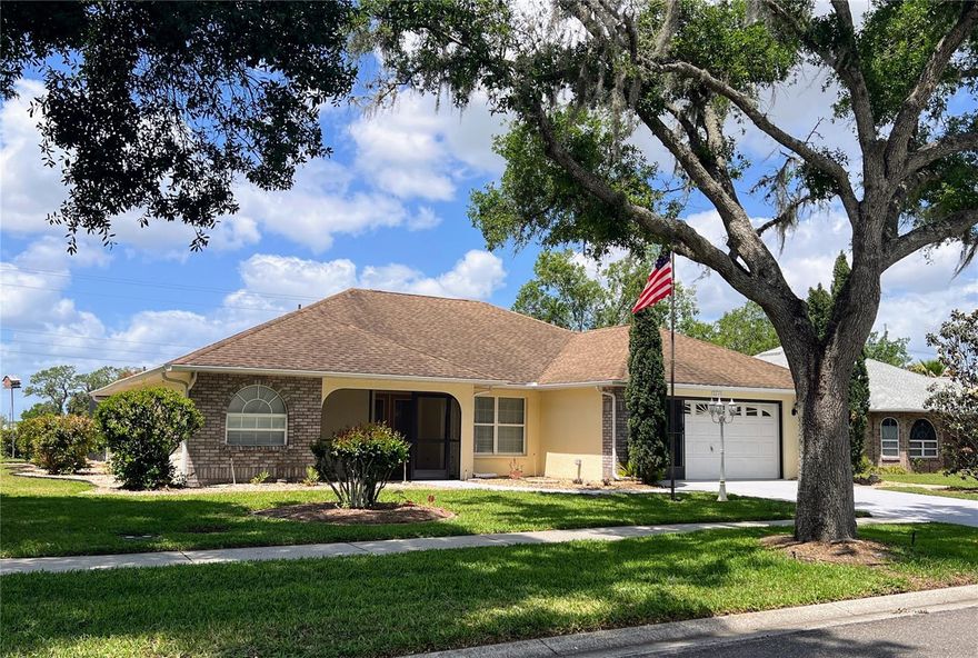 Spacious Florida living in the Heart of Wesley Chapel / Zephyrhills!  **MORE PHOTOS COMING** Discover comfort, functionality, and privacy in this beautifully designed 3-bedroom, 2-bath home featuring a highly desirable split-bedroom floor plan—the ideal balance of open living and personal space. The split-bedroom design provides a private owner’s retreat, while the additional bedrooms are thoughtfully positioned on the opposite side of the home—ideal for hosting guests or creating a quiet workspace. The spacious Great Room with dining area features rich hardwood floors, creating a warm and inviting space ideal for entertaining. Just off the main living area, the breakfast room with tile flooring flows into the updated kitchen, complete with stone countertops and convenient pull-out cabinet baskets creating ease for everyday living. Enjoy true indoor-outdoor living with French doors from both the Great Room and the Primary Suite leading to your private patio and pool oasis. Relax or entertain under the 9x22 covered patio, all overlooking a refreshing in-ground pool within a screened enclosure This well-designed floor plan offers a private retreat in the Primary Suite, featuring a luxurious ensuite bath with walk-in shower, separate soaking tub, marble style surrounds and countertops, and a private water closet. Additional highlights include an oversized attached garage with utility sink, providing ample storage and convenience. Prime Location! Situated just minutes from hospitals and medical facilities (within 2 miles), plus easy access to grocery stores, restaurants, and major retailers. Commuting and travel are a breeze with Tampa International Airport less than an hour away, and Florida’s top attractions all within a convenient 1–1.5 hour drive. Live where others vacation—this home truly has it all! Schedule your private showing today and experience Florida living at its finest before it's gone!