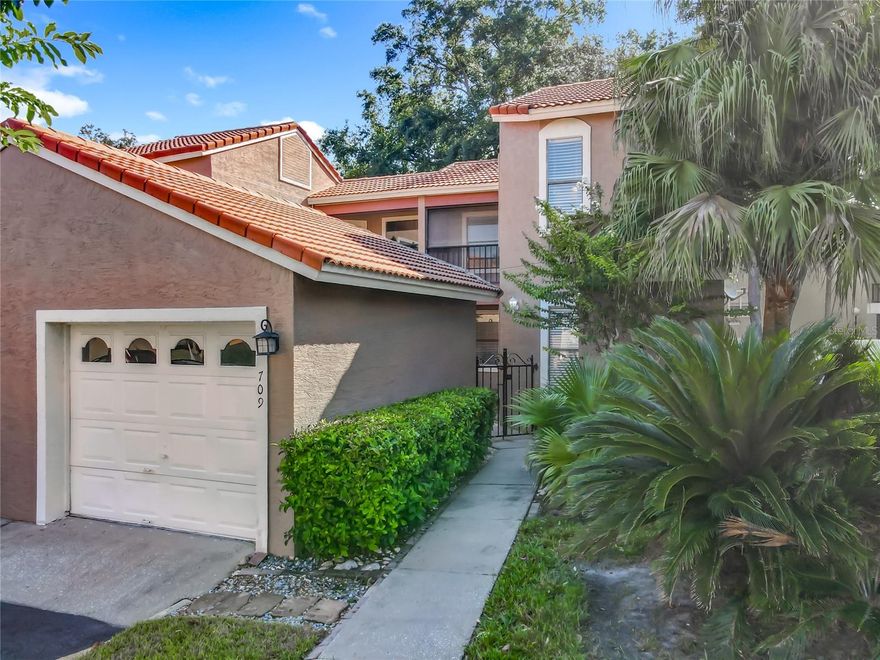 Welcome to your dream Mediterranean-style townhome in the exclusive gated community of St. Tropez. This elegant 3-bedroom, 2-bathroom residence offers a perfect blend of style and functionality. Upon arrival, you'll be greeted by a charming gated entry leading to a serene courtyard, ideal for a patio setup or a lush potted garden. The property includes a detached one-car garage & one parking spot for your convenience.

Step inside to discover a thoughtfully designed floor plan with a spacious layout, featuring vaulted ceilings and luxury vinyl plank flooring throughout most of the home. The gally kitchen is a chef's delight, boasting solid stone countertops and sleek stainless steel appliances. 

The main floor hosts a luxurious primary suite complete with a walk-in closet, providing a private retreat. Upstairs, you'll find another primary suite, an additional bedroom, Jack & Jill Bathroom and balcony overlooking the front courtyard.

Enjoy outdoor living with a private fenced back patio and wood deck perfect for relaxation or entertaining. The home is equipped with a comprehensive whole-house water filtration system and a state-of-the-art Vivint Home Security System, ensuring peace of mind.

Centrally located in Altamonte Springs, this home offers easy access to major highways including I-4 and 414, as well as nearby Longwood. Experience the perfect combination of convenience and luxury. Schedule your showing today and make this exquisite townhome your own!
