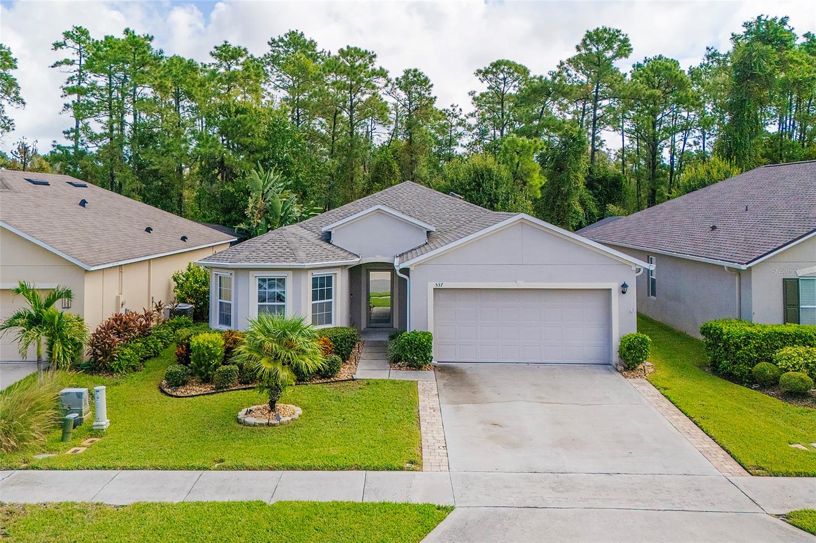 Welcome to your peaceful, like-new, and well-updated oasis in the desirable New Smyrna Beach community, Sabal Lakes. This highly-cared-for home features a new roof (2025) and new HVAC (2023) for your peace of mind. Perfect for first-time buyers, retirees, growing families, and everyone in between, this spacious and versatile floor plan accommodates many needs. Around the exterior you will appreciate the crisp landscaping and the private, extended lanai overlooking a tranquil nature preserve, while inside the list of upgrades is nearly endless. Recessed lighting, beautiful tile flooring, and custom ceiling fans adorn the living areas while the kitchen boasts granite countertops, Samsung stainless steel appliances, and ample cabinetry. The welcoming primary suite features a custom closet system while in the primary bath you will find an illuminating sun tunnel, a dual sink vanity, and a walk-in shower with grab bars. Other features include a Ring doorbell, leaf filter gutter system, storm panels, and more. Sabal Lakes provides residents with a sparkling community swimming pool, and the neighborhood is just minutes from interstate access, shopping, dining, public schools, and of course, beach access! Come see this quality home today!
