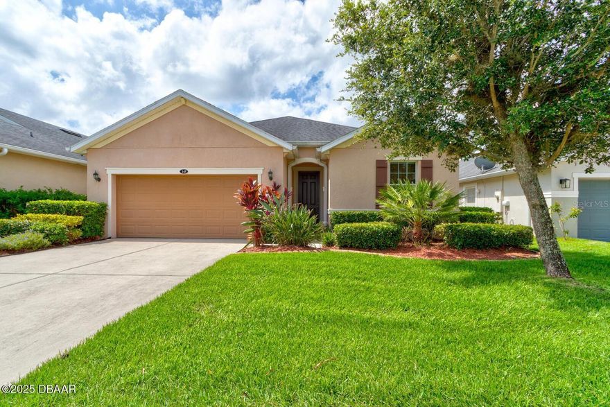 Welcome to this stunning 4-bedroom, 2-bathroom Energy Star Certified residence nestled in the desirable Grande Champion neighborhood at LPGA. Boasting soaring nine-foot ceilings and a bright, open layout, this home is ideal for both comfortable living and effortless entertaining. The chef's kitchen is a true centerpiece, featuring elegant 42-inch cabinetry, sleek granite countertops, and an expansive breakfast bar with room for five. The kitchen flows seamlessly into the spacious living and dining areas, creating a warm and inviting atmosphere. Retreat to the generously sized primary bedroom, complete with a large walk-in closet equipped with built-in organizers. The en-suite bathroom offers dual granite vanities, a relaxing garden tub, and a separate walk-in shower. Each additional bedroom offers plenty of space, ceiling fans, and thoughtfully designed closets with organizers to keep everything tidy. Step outside to enjoy the beautifully landscaped yard with decorative concrete edging, a full irrigation system, and a covered patio perfect for outdoor dining or morning coffee