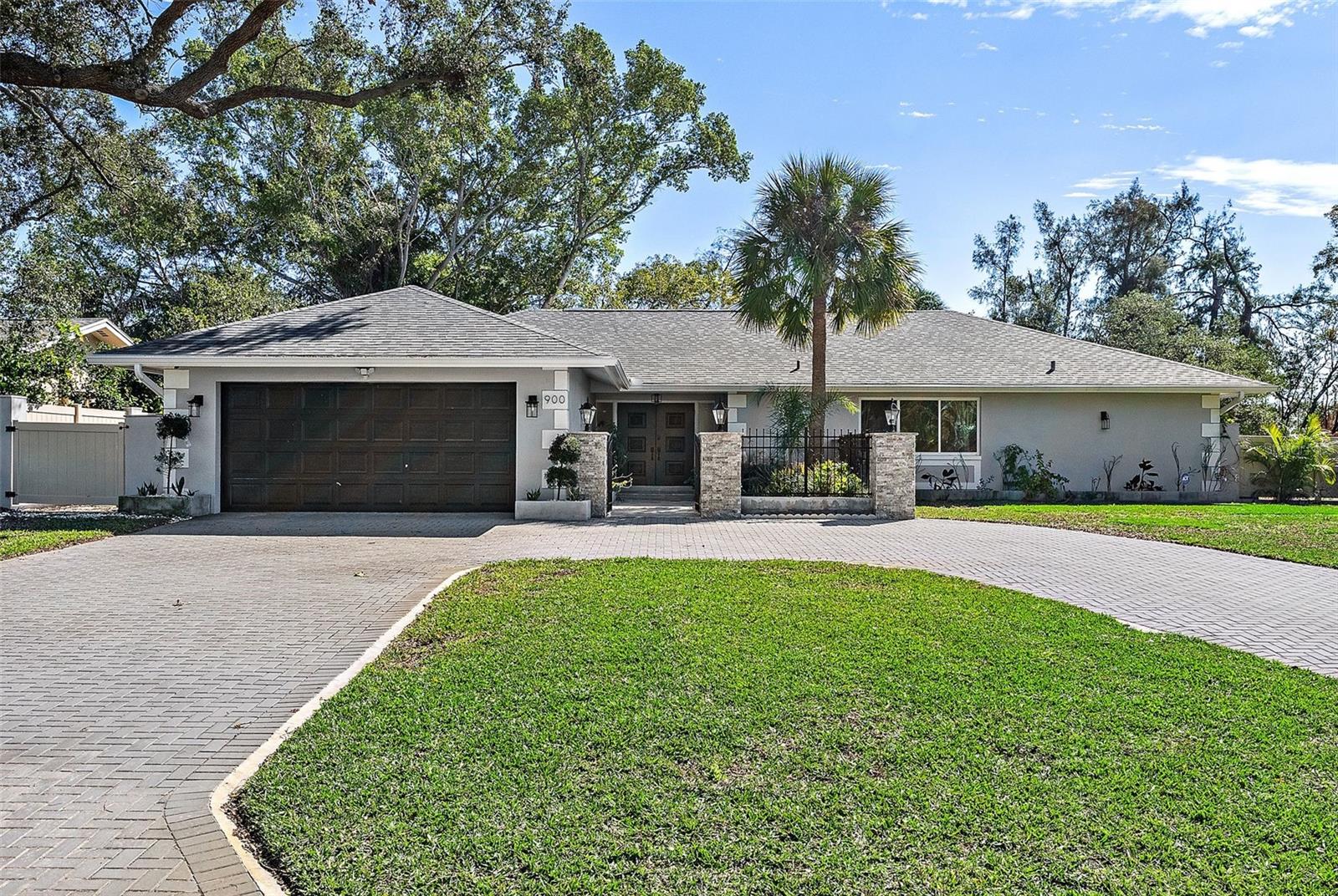 Nestled right on the Vinoy Golf Course, in prestigious Snell Isle Estates! With only 33 homes in this coveted neighborhood, properties like this rarely come available. This exquisite 5-bedroom, 4-bathroom home offers the perfect balance of luxury and comfort on a sprawling, nearly half acre corner lot. High and dry, this home had no flooding issues in either hurricane! Recently updated in 2023, this home combines timeless elegance with modern design, featuring sleek marble tile, custom cabinetry, and an abundance of natural light. As you approach the home, you're greeted by lush landscaping and a stunning courtyard entry, setting the tone for the sophisticated interior. The heart of the home is its gourmet chef’s kitchen, complete with gleaming quartz countertops, Thermador appliances, gas cooking, and built-in refrigeration — a true culinary masterpiece. Whether you're entertaining or simply relaxing, the open living and family rooms, with built-in entertainment center and a cozy fireplace, offer a seamless flow to the outdoor pool deck through sliding glass doors that pocket all the way back, blending the indoors with the stunning backyard oasis. The owner’s suite is an elegant retreat, featuring dual walk-in closets with custom luxury systems, and a spa-inspired bathroom with marble accents, a soaking tub, and a rain shower system that promises total relaxation. The home is built for both relaxation and entertainment with a private backyard oasis that includes a Pebbletec pool and spa, a covered dining area, and 8-hole putting green complete with sand bunkers. With a fully fenced yard, the space offers both privacy and versatility for outdoor activities. Beyond the impeccable finishes and expansive living areas, this home also features the peace of mind that comes with hurricane-proof windows, a new roof, new plumbing, electrical upgrades, and energy-efficient systems. Located adjacent to the renowned Vinoy Golf & Country Club and just minutes from downtown St. Petersburg, the St. Pete Pier, museums, dining, shopping, and beaches, this home offers the ultimate in luxury living.