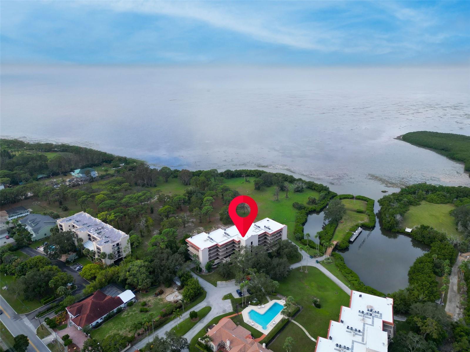 GORGEOUS waterfront Condo in the desirable location of Gulf Front Lagoon with IN-LAW/GUEST SUITE with PRIVATE ENTRANCE! Two homes in one! Gated and very secure community. Meticulously maintained! Pride of ownership abounds! Beautiful kitchen with granite countertops, breakfast bar, lovely soft close cabinets and stainless appliances. Open concept living/dining area with crown molding and wood-burning fireplace. Tile flooring throughout condo. Newer tilt-in windows, slider and hurricane shutters throughout condo. Two outdoor spaces…a large balcony off of the kitchen and a screened-in lanai with serene views of the Gulf and of the protected nature preserve. Breathtaking lanai has Armorvue windows, ceiling fans, blinds and remote controlled hurricane shutters. The Armorvue windows have screens and tilt-in for easy cleaning. The lanai alone is like a vacation retreat! The primary suite has lanai access, walk-in shower and double closets and an en suite bath with double sinks and a seated shower. The in-law/guest suite, with private entrance, has a full bath with seated shower. Large laundry closet with storage and newer washer and dryer. Whole House Water Softener. A/C 2018. Hot Water Tank 2024. Roof 2024. Tuscan inspired clubhouse with fitness center, full kitchen, event space, a pool with tropical landscaping and a scenic boardwalk leading to the private marina and a fishing pier. Have a boat? Boat slips are available for purchase! Garage parking underneath building, secure elevator access to condo and dedicated storage unit. Located minutes from Sunset Beach, Fred Howard Park, Tarpon Springs downtown and Sponge Docks, restaurants, coffee shops, airports and the Pinellas Trail. Complex has conducted and passed the Milestone Inspection. NO WATER entered the ground floor garage which remained DRY last year! THIS is the Ultimate in LUXURY Florida Coastal Living!